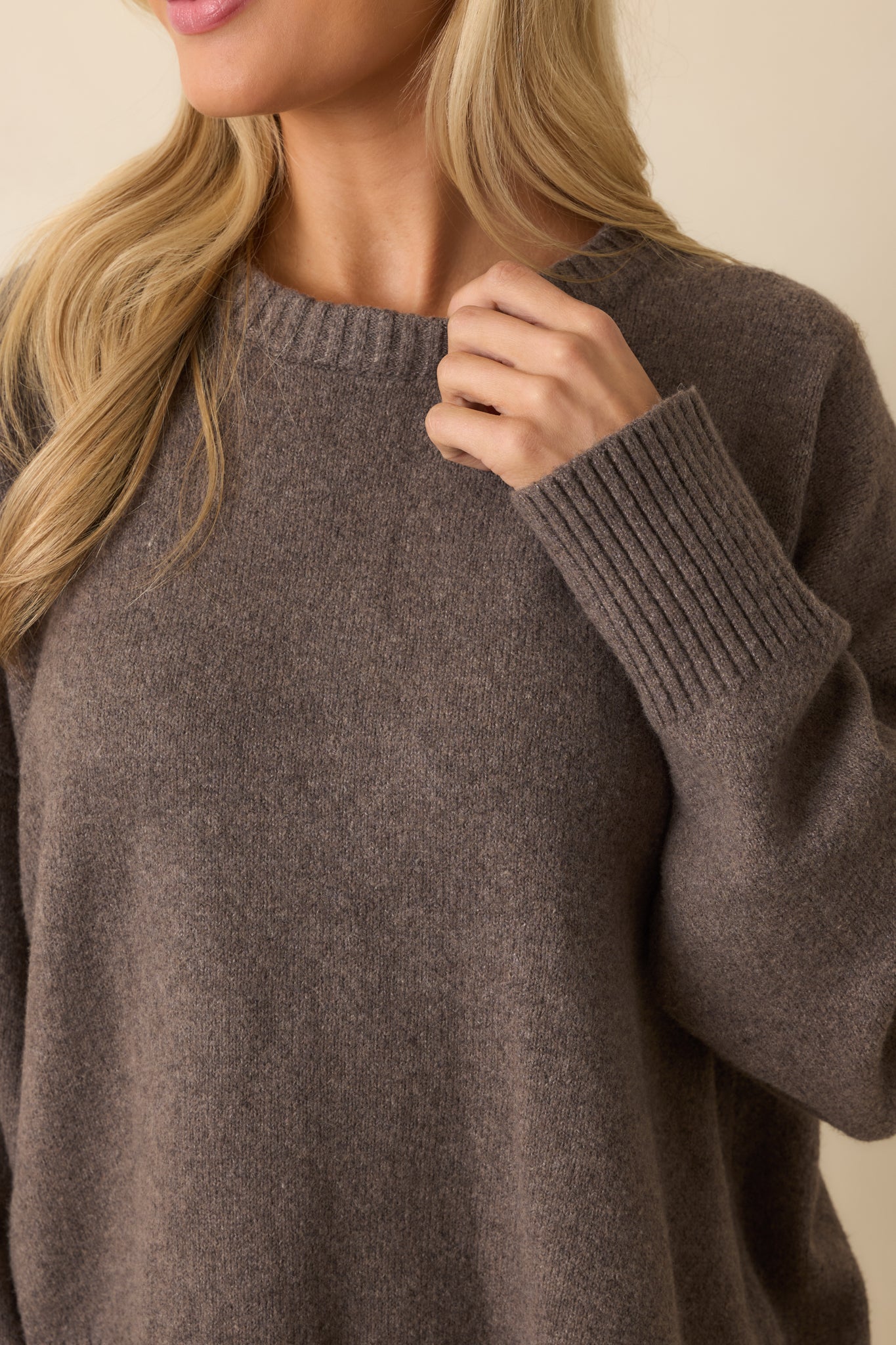 Close-up of the soft fuzzy knit fabric, ribbed cuff, and hem, capturing the texture and craftsmanship.