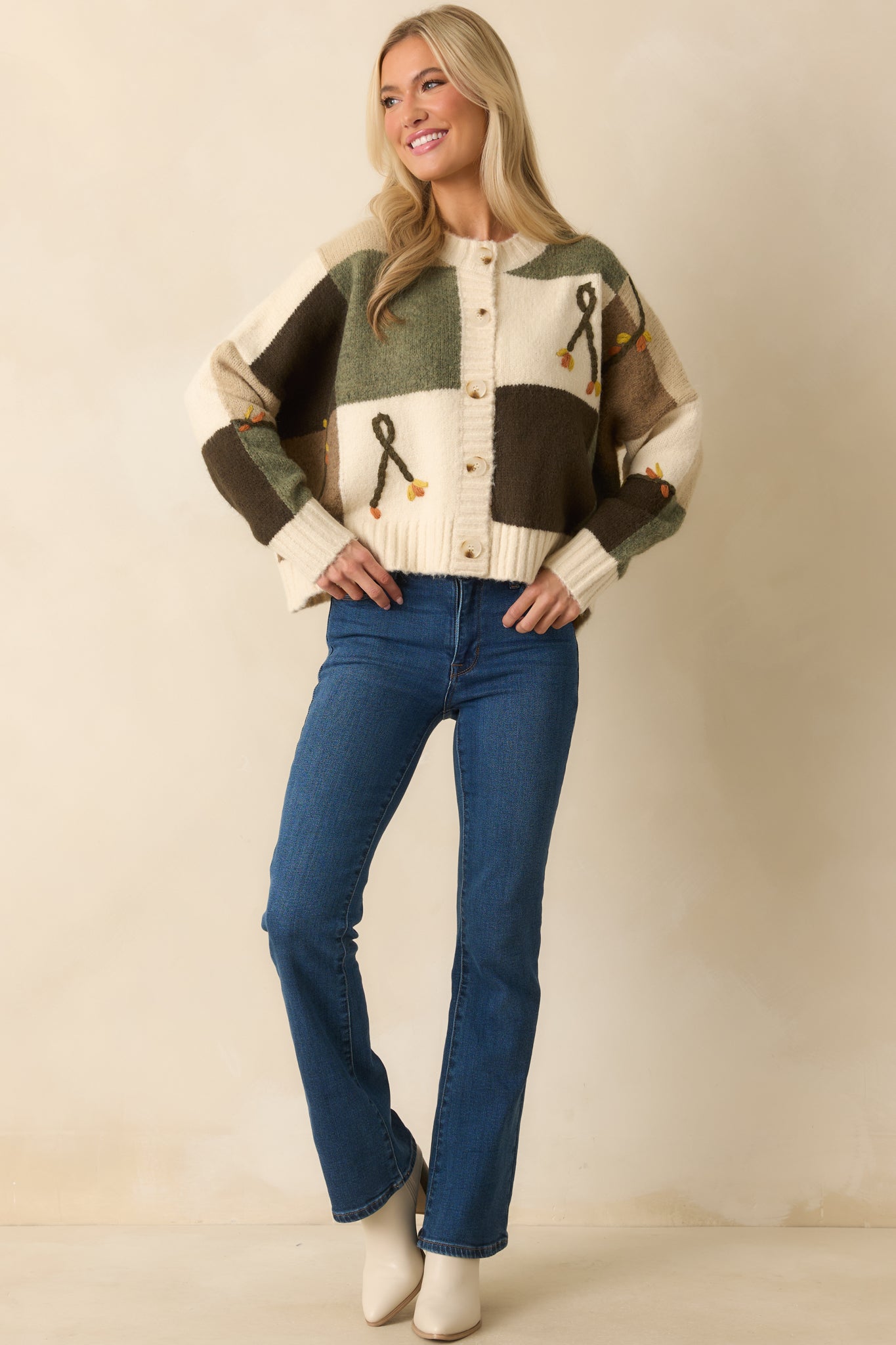 A full-length front view of the colorblock ivory cardigan showing long sleeves and a functional button front.