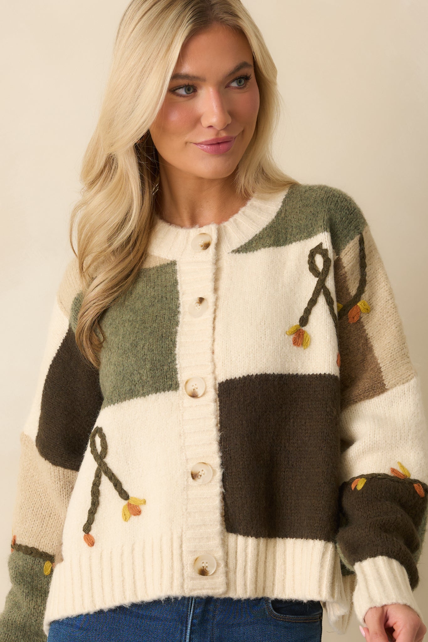 A cropped close view of the sleeve and torso area highlighting the knit texture and color variation.