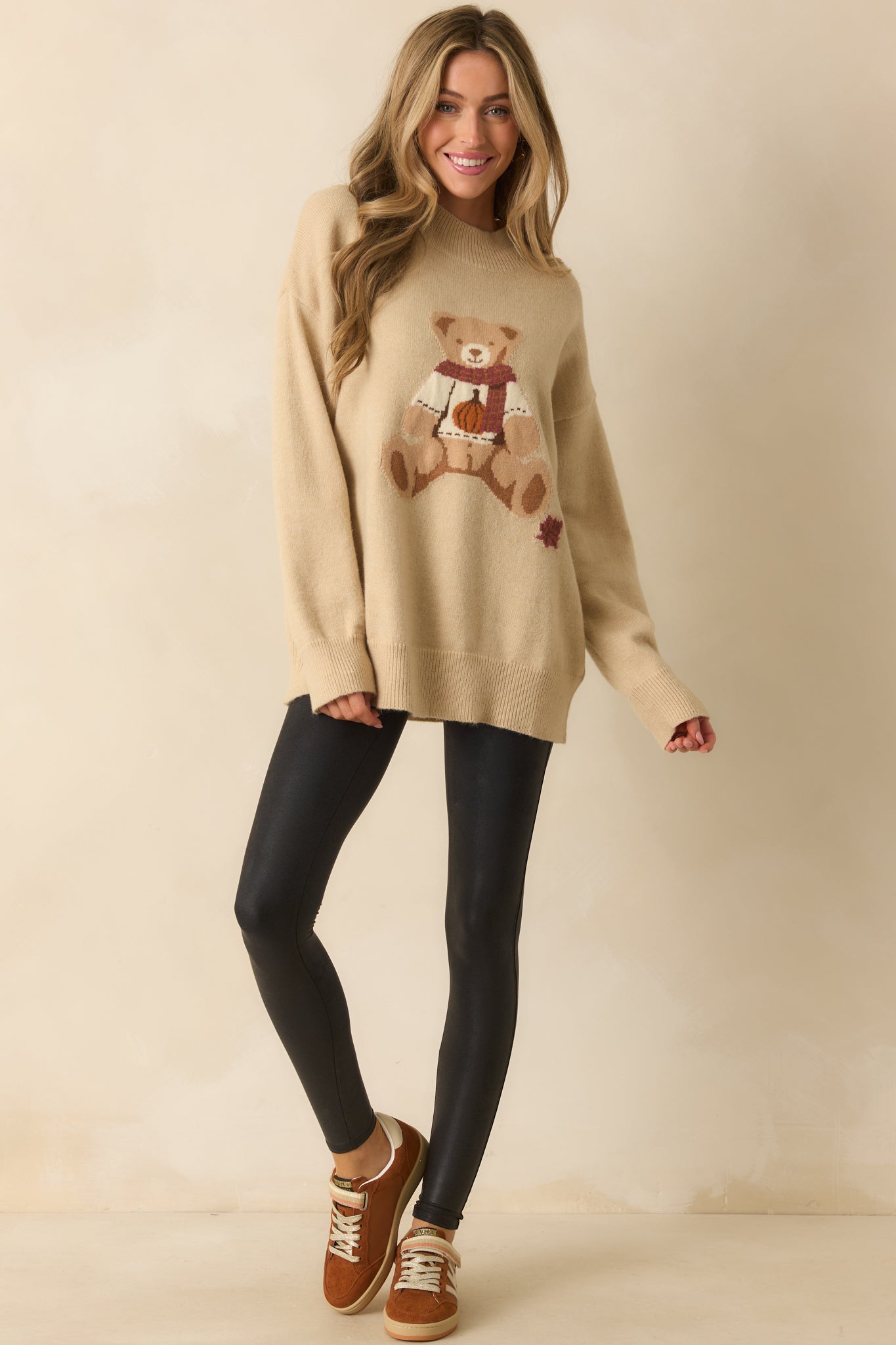 A full-length front view of the black leggings showing the sleek fitted shape and ankle-length cut.