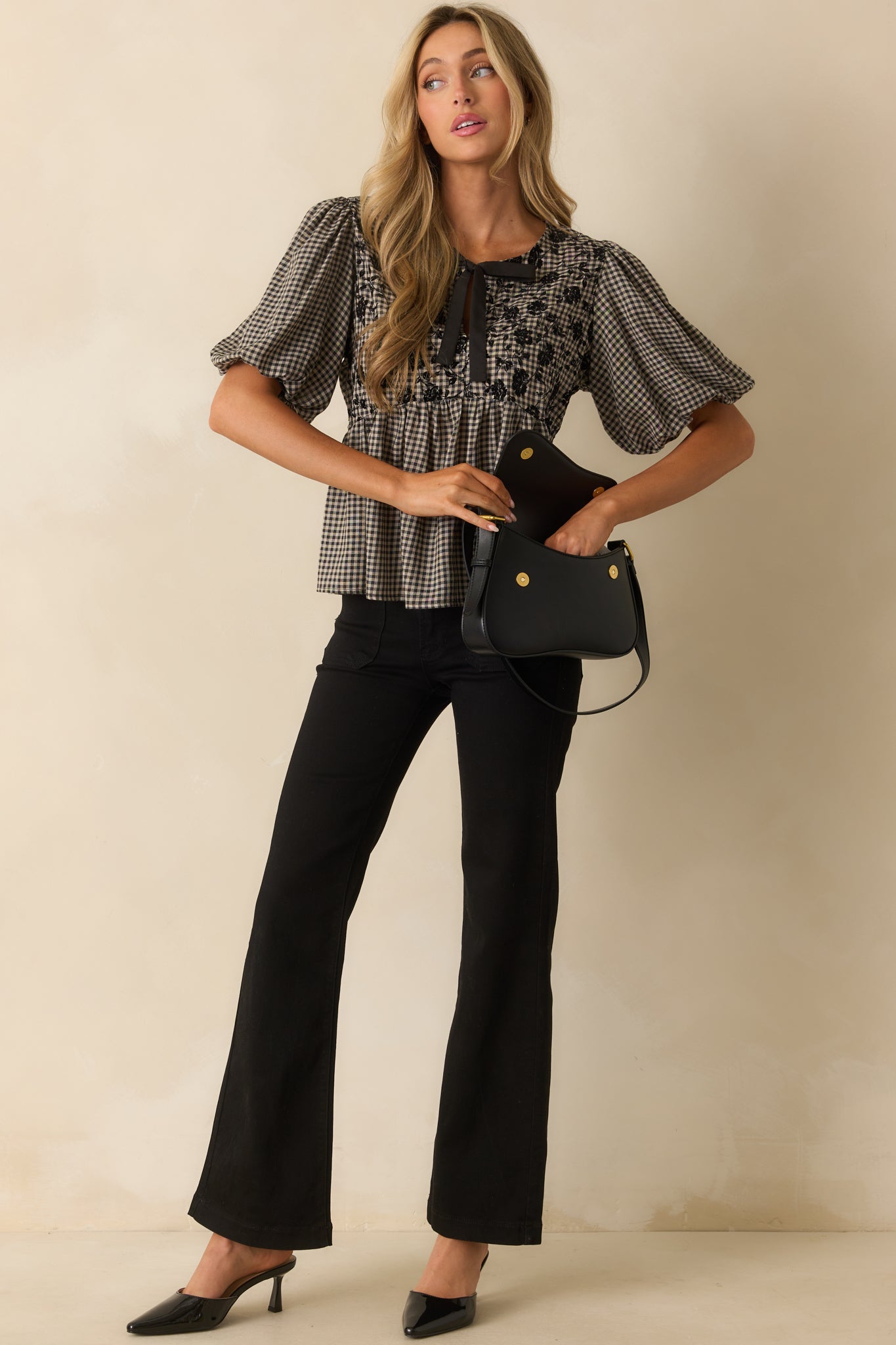 Peplum silhouette top featuring short puff sleeves with elastic cuffs and gathered waist seam.