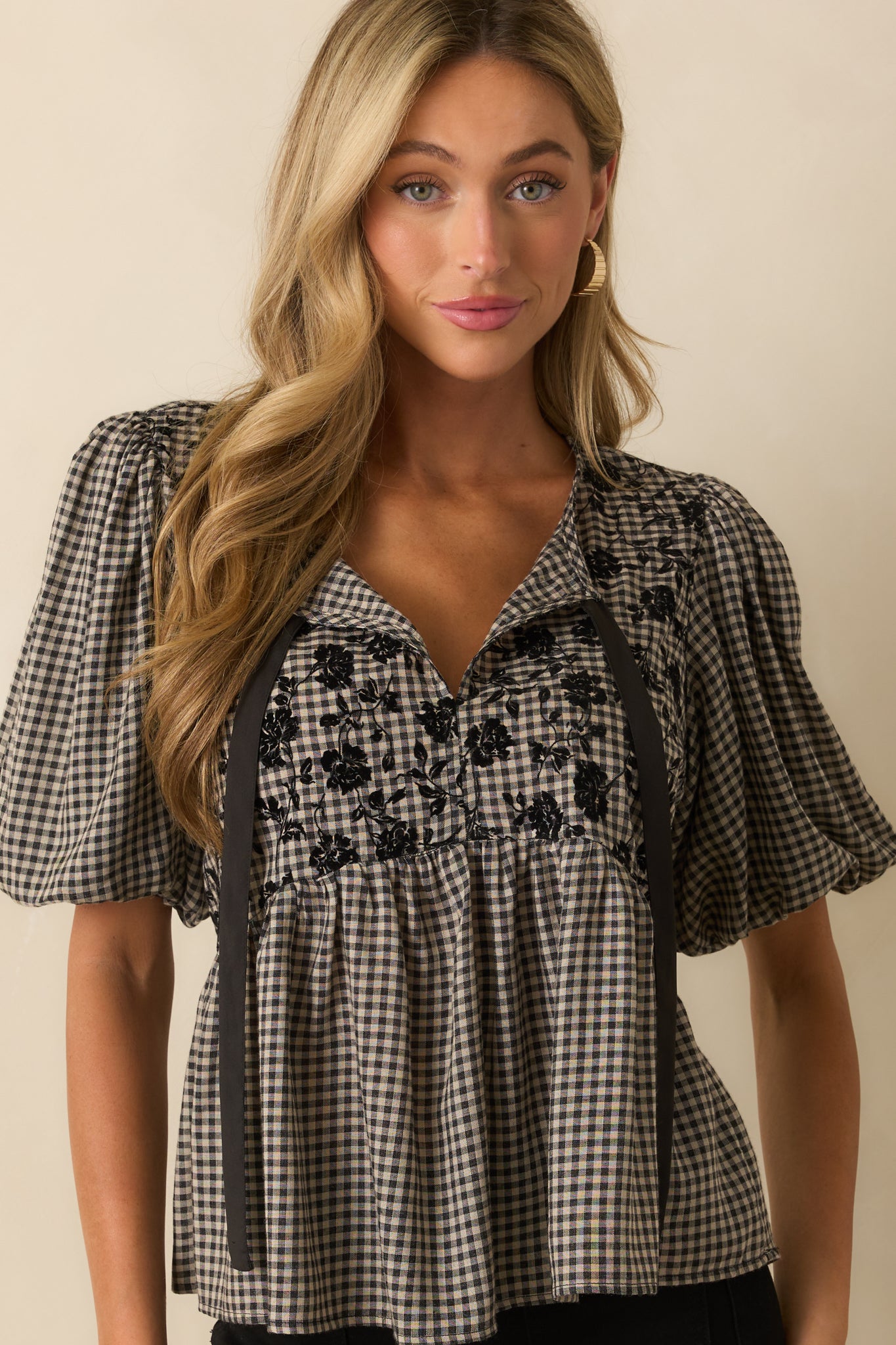 Top showing puff sleeves with elastic cuffs and gingham print detail.
