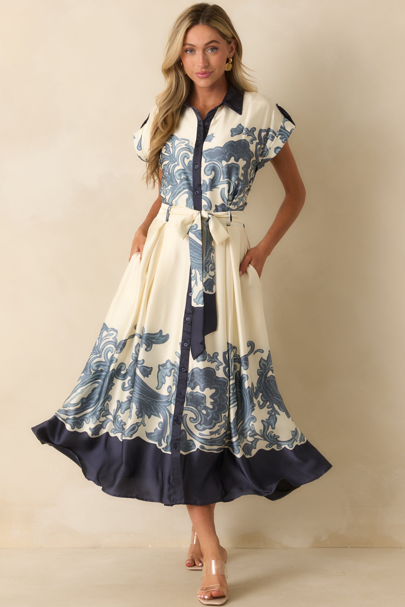 Front view of ivory maxi dress featuring functional button front, optional self-tie sash belt, and contrast trim along the edges.