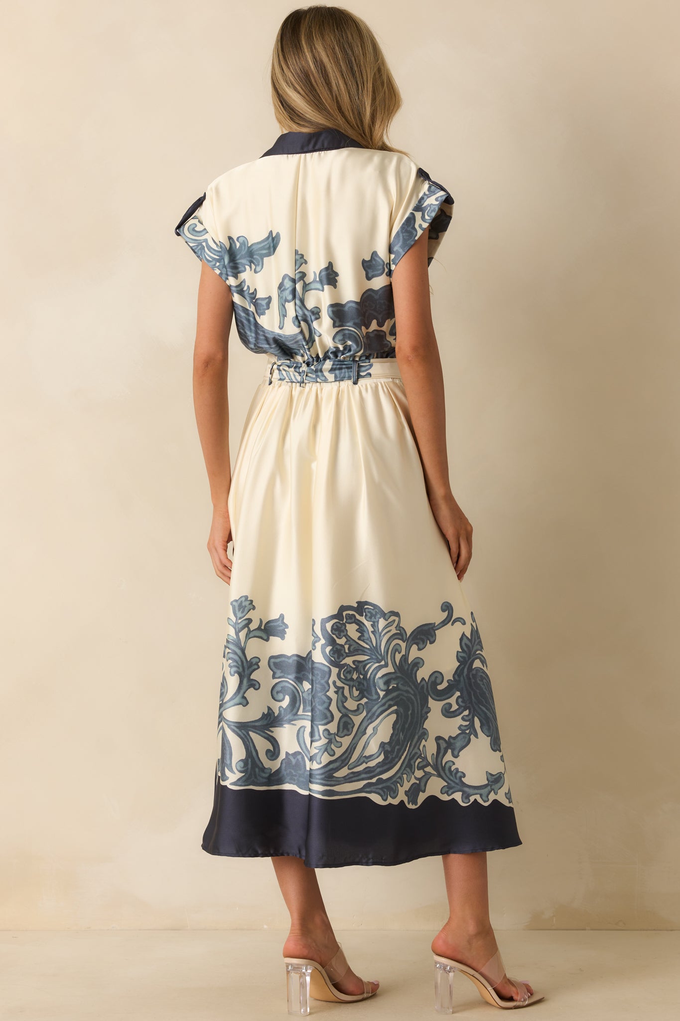 Rear view of maxi dress showing elastic back waistband insert, flowing hem, and structured silhouette.