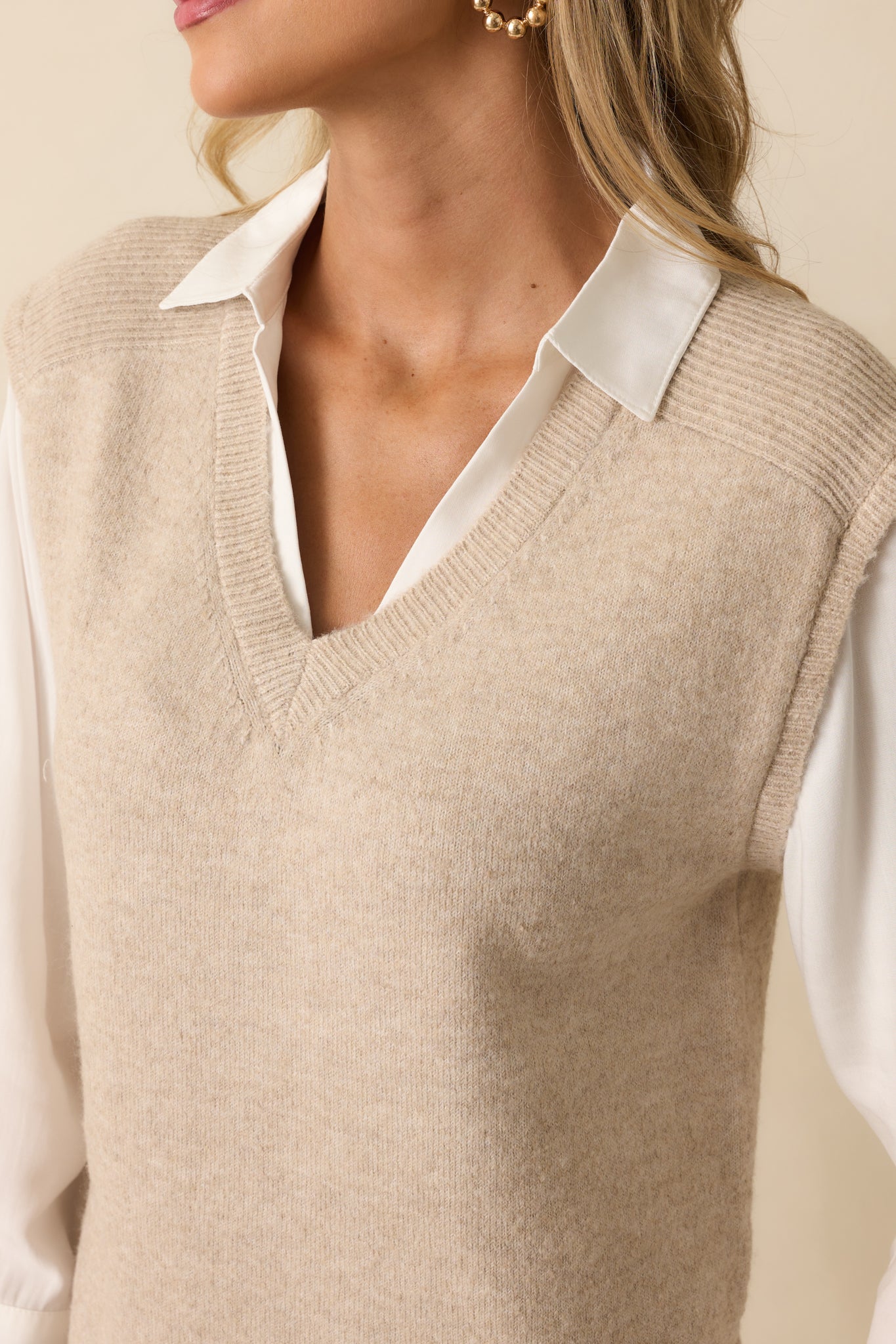 Detailed look at the ribbed hems and built-in faux white shirt layer.
