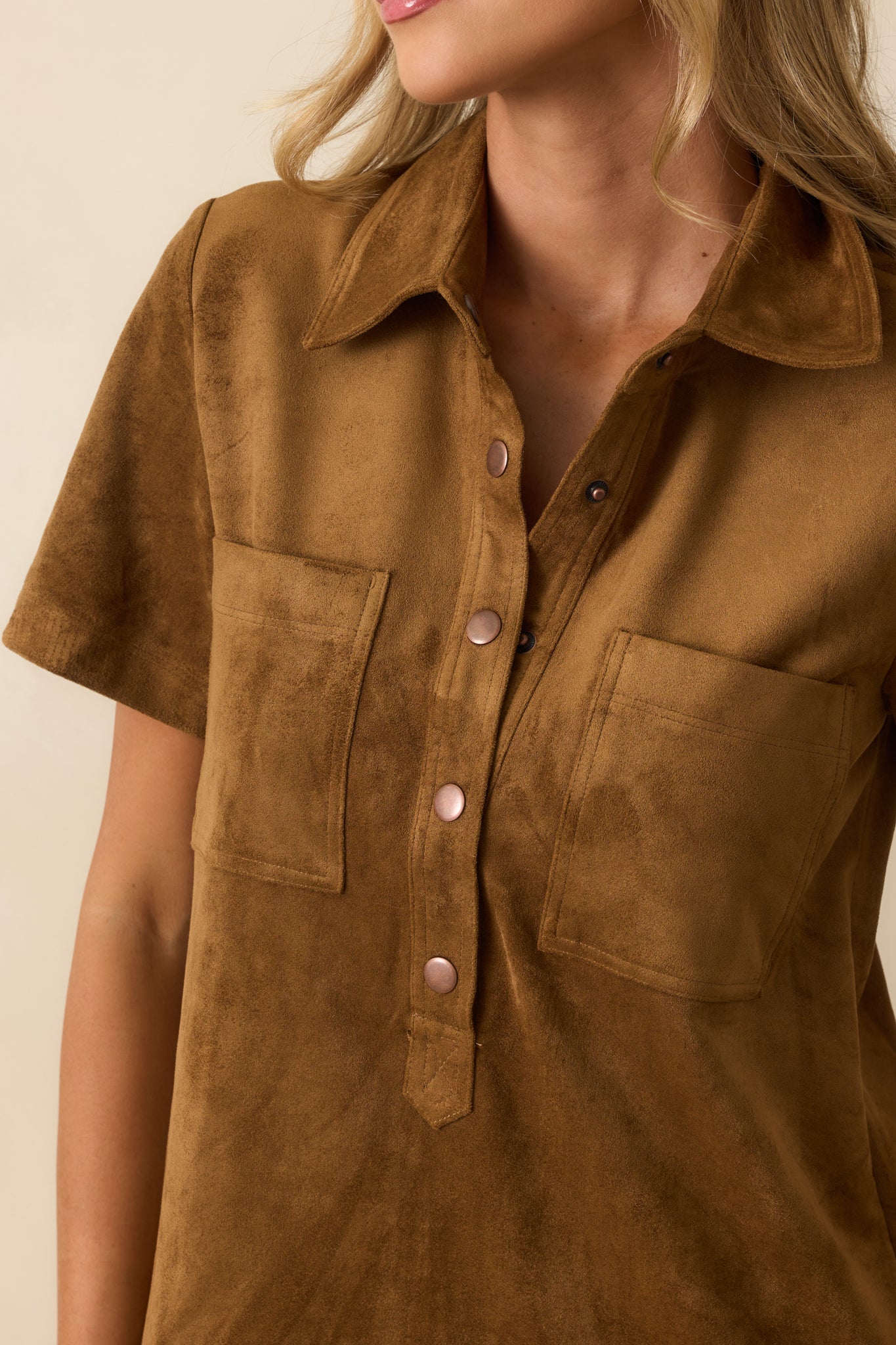 Close-up of the collared neckline and functional snap buttons, showcasing the soft faux suede texture.