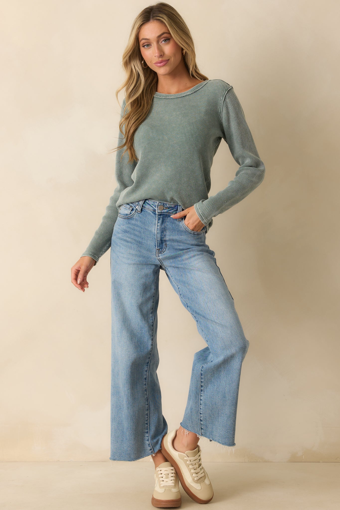 Sage green long-sleeve thermal top featuring crew neck and textured waffle fabric throughout.