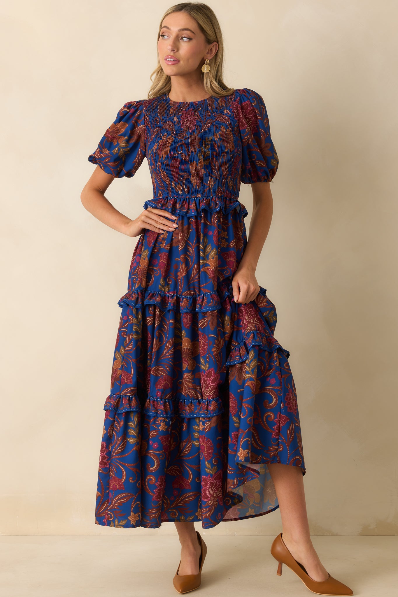 Smocked bodice navy dress showcasing a colorful floral paisley pattern.