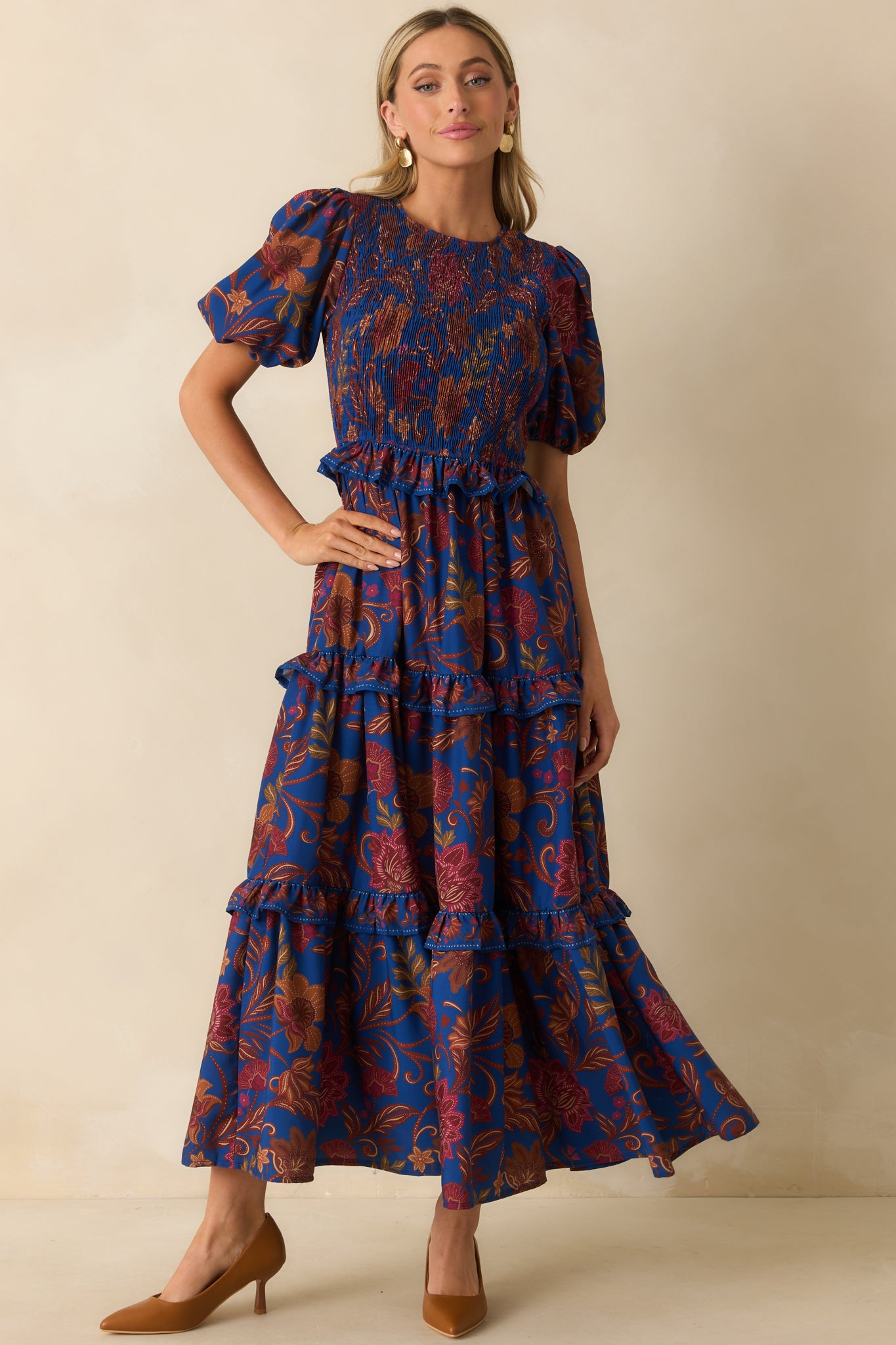 Flowing navy dress featuring short puff sleeves with elastic cuffs and a round neckline.