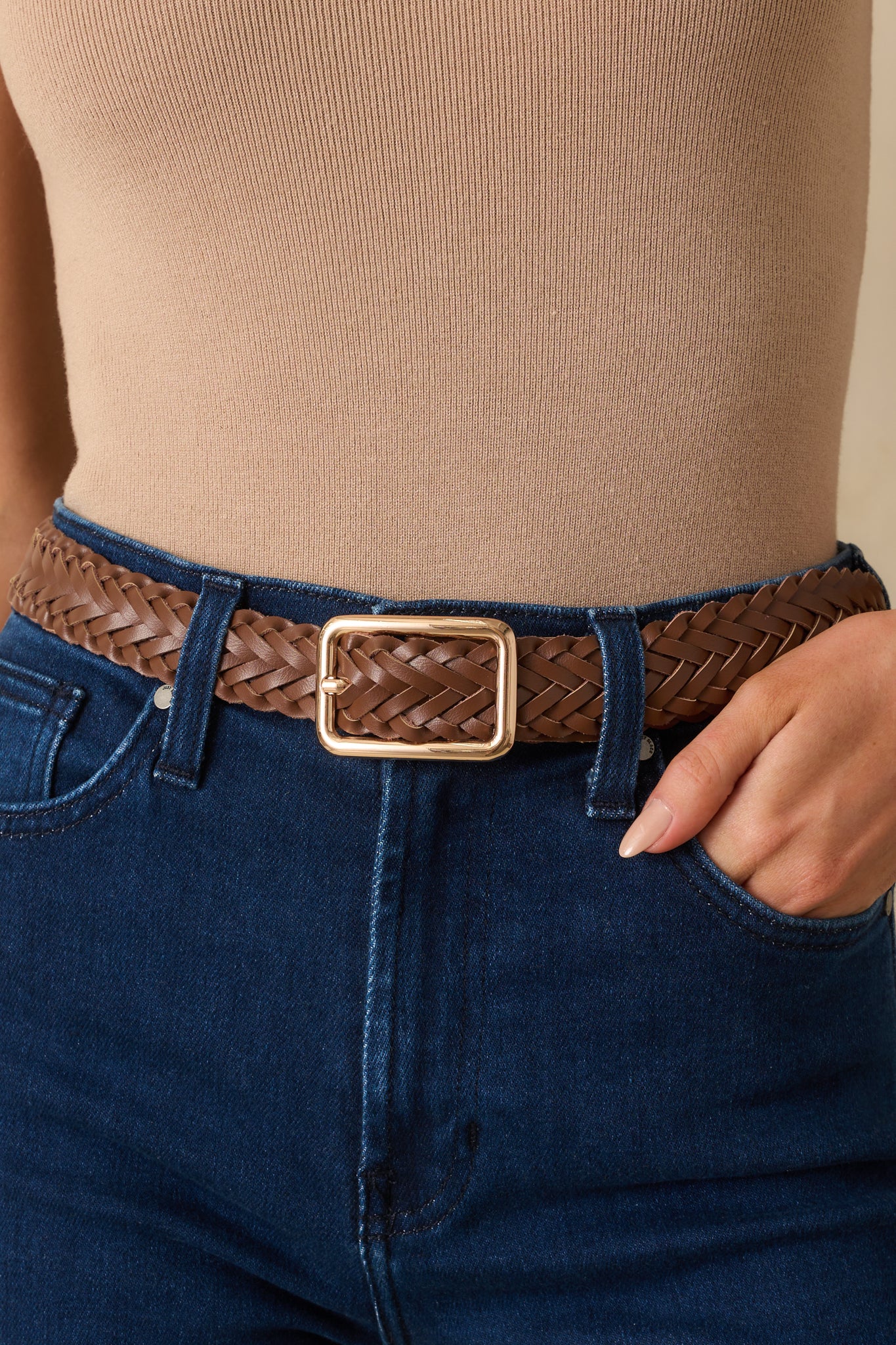 Close-up of the gold rectangular buckle and dark brown braided strap, showing woven detail.
