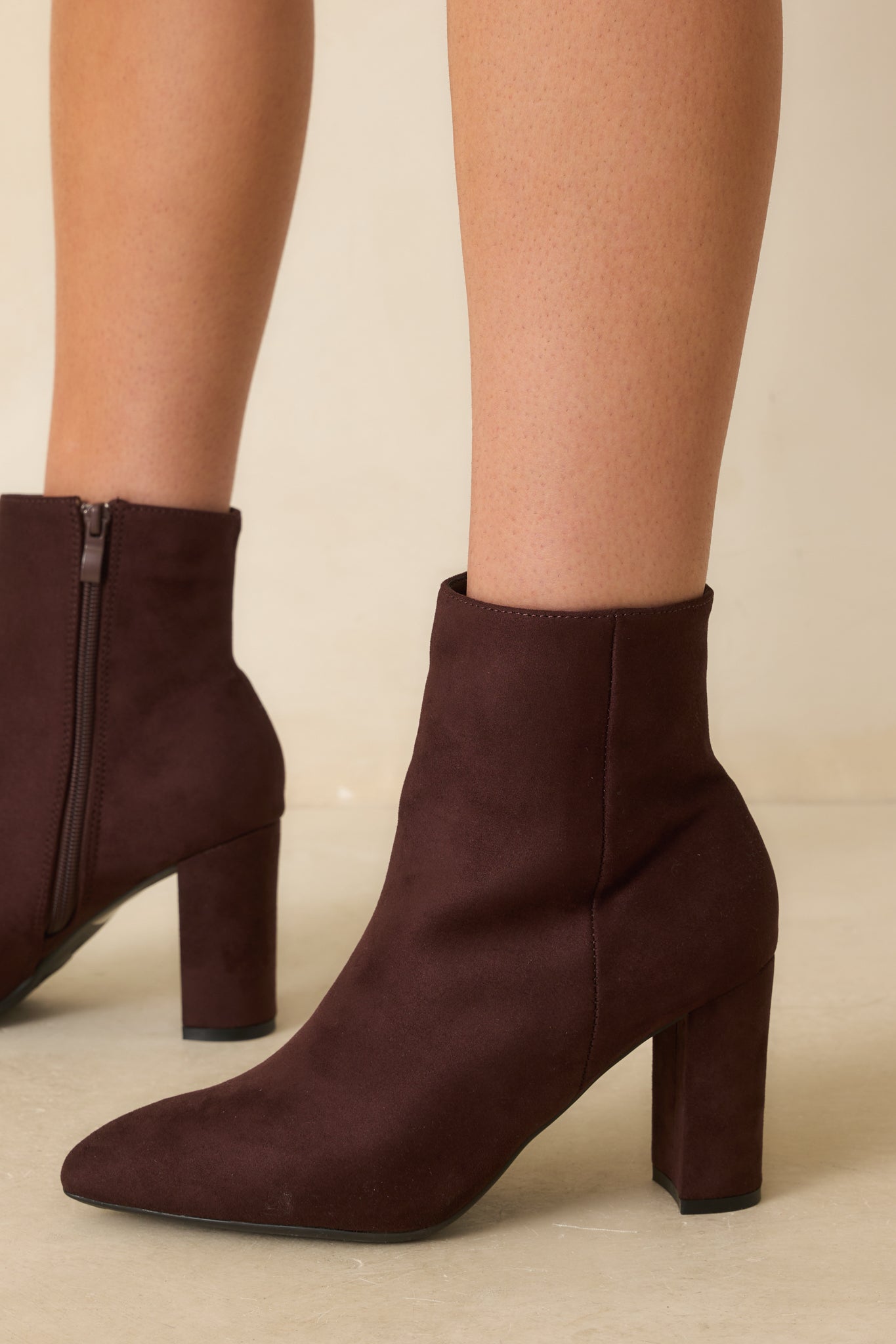 Close-up detail photo capturing the texture of the faux suede and precise stitching.