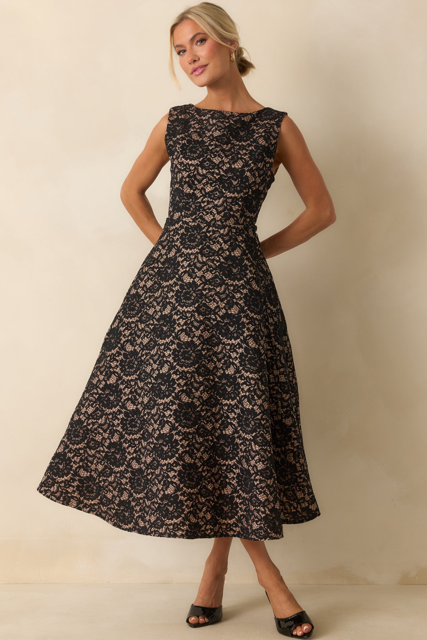 A-line lace midi dress with a fitted waist and delicate floral detailing against a nude-toned underlay.