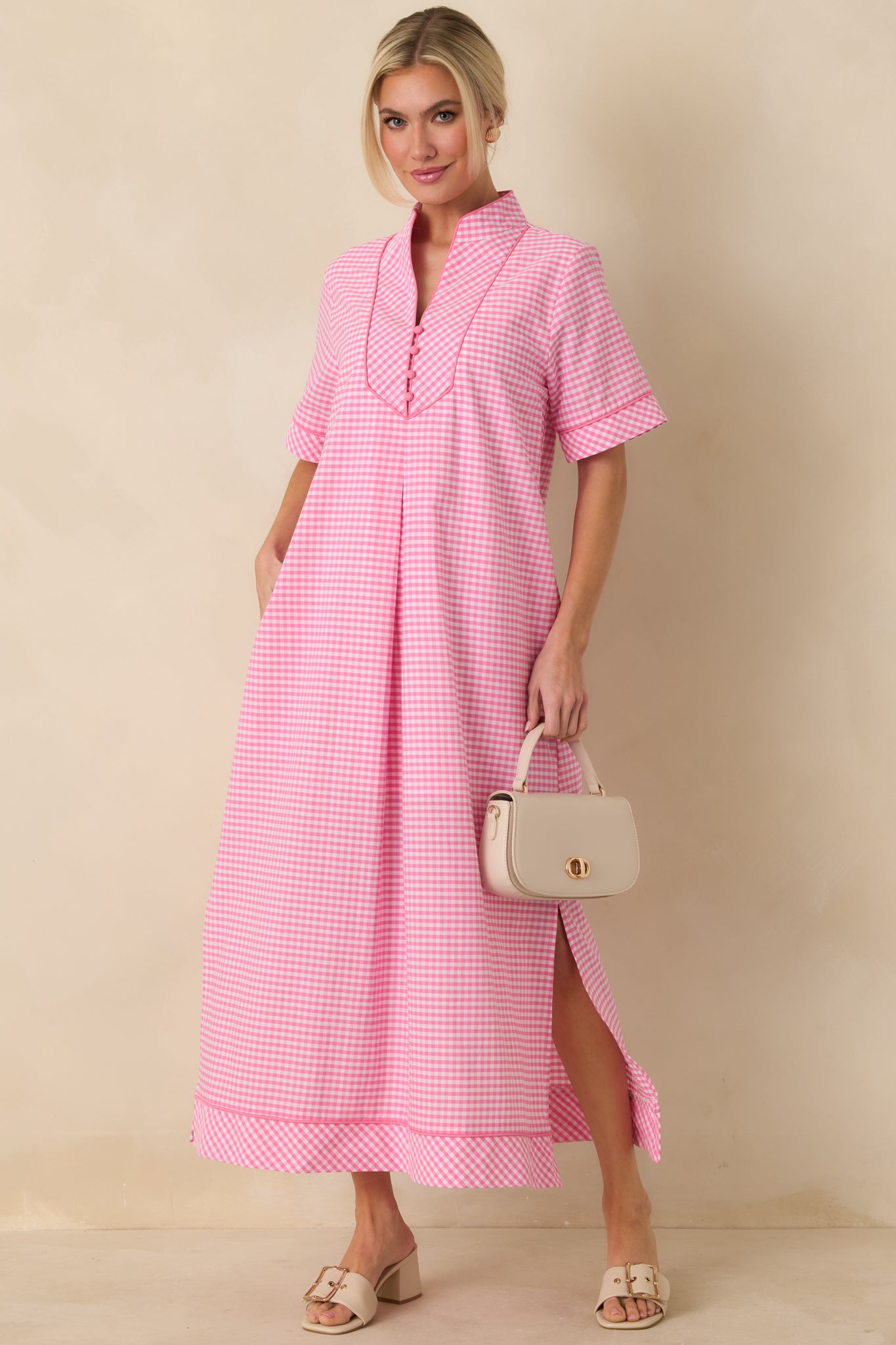 Front view of a pink gingham maxi dress highlighting the softly structured shape and breezy fit.