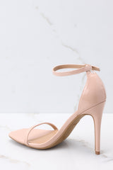Inner-side of these shoes that feature an adjustable ankle strap, a thin strap over the foot, and a thin heel.