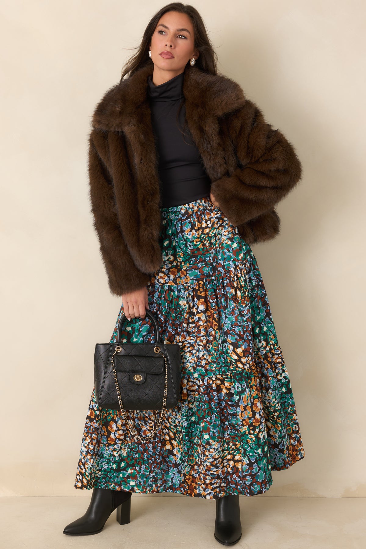 Tiered skirt featuring an abstract animal print in rich green, blue, rust, and ivory on black.