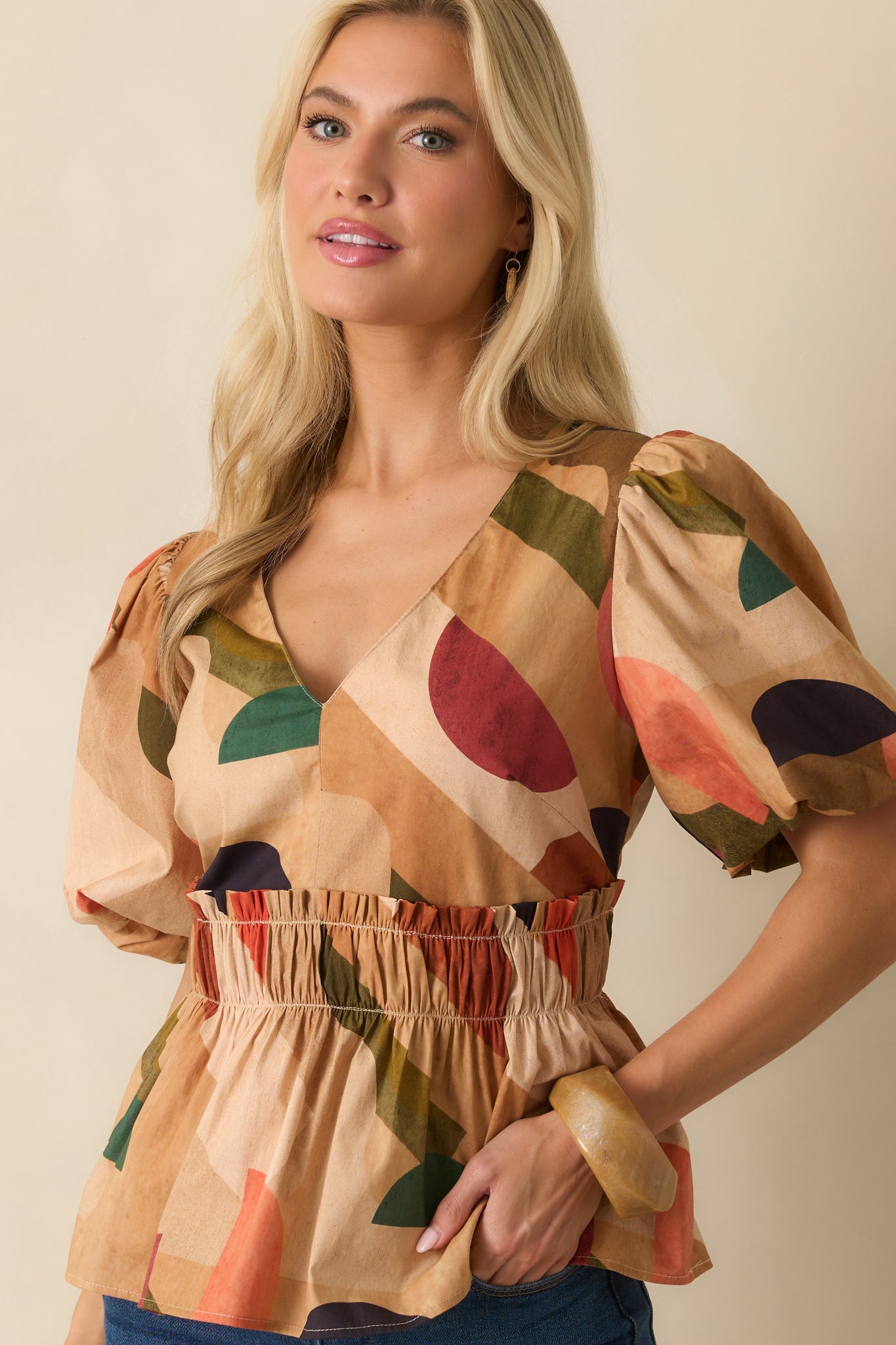 Cropped shot emphasizing the abstract print pattern and fabric texture.