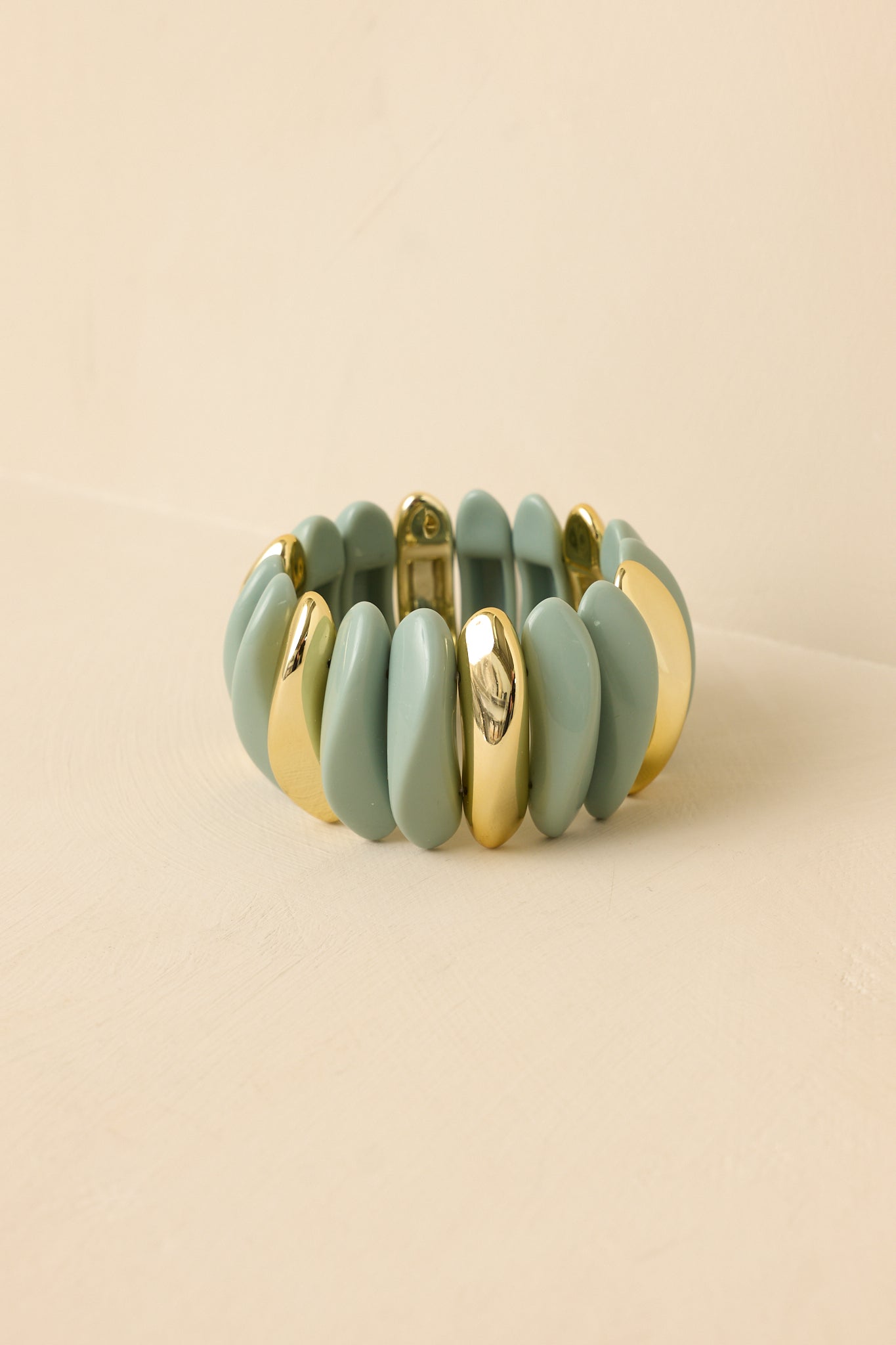 Stretch bracelet with abstract sage links and gold accents shown from a different angle.
