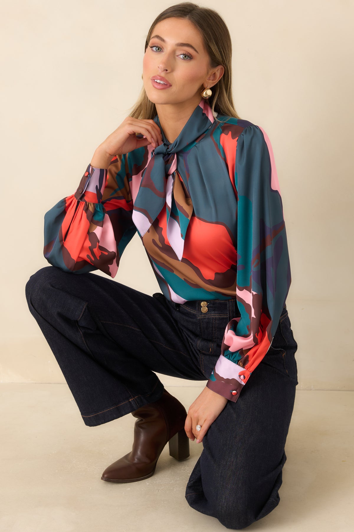 Abstract satin-finish top with a removable tie neckline and sweeping multicolor shapes.