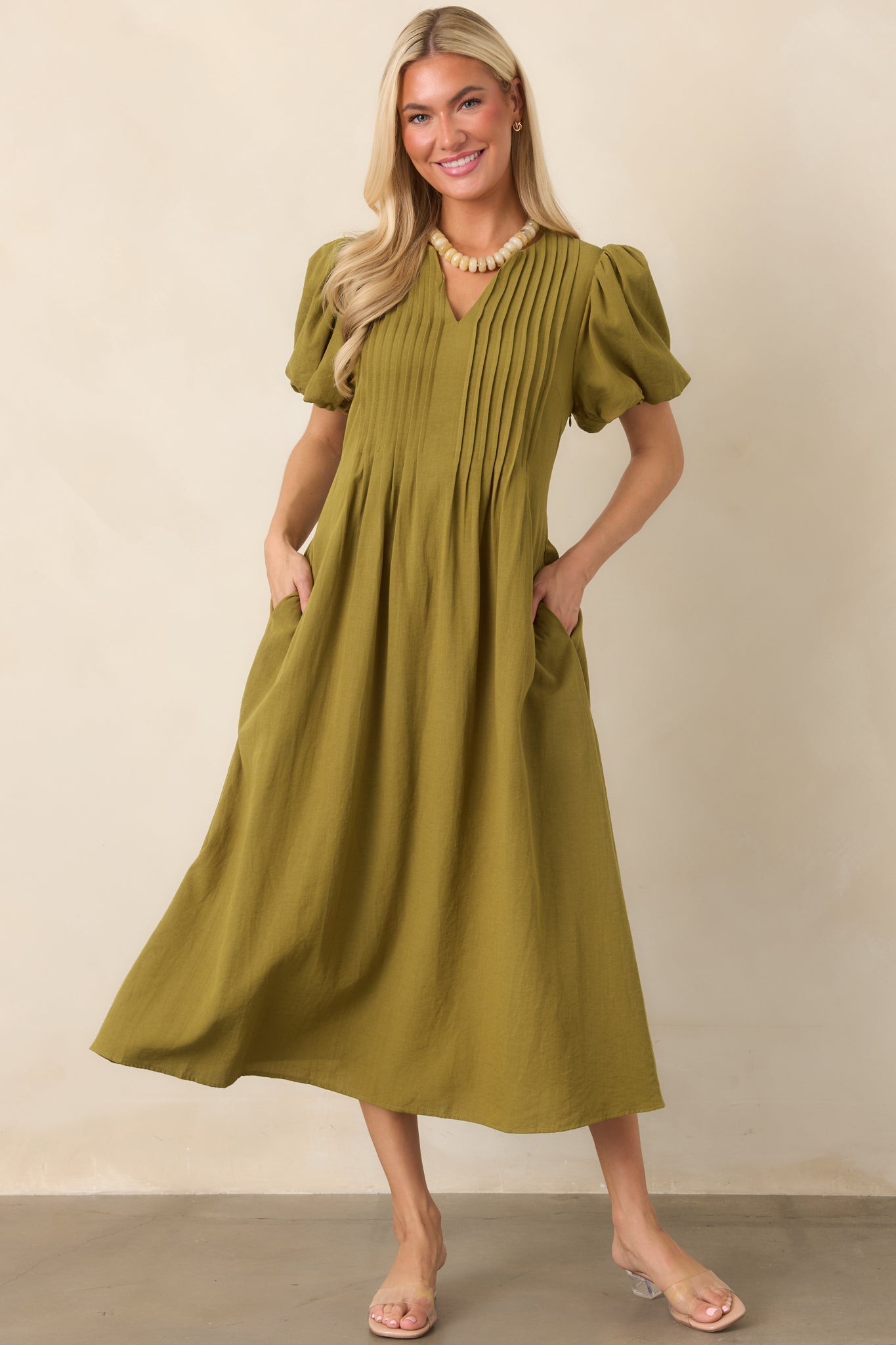 Airy rayon-nylon midi dress showcasing a linen-like surface, relaxed V-neck, dimensional sleeve gathers, and a fluid full-length skirt.