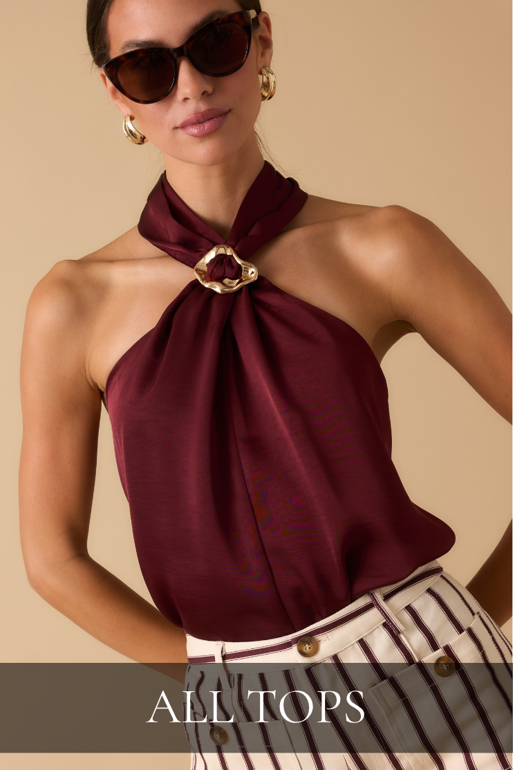 Model wearing sunglasses, a red satin top, and striped pants. All Tops.