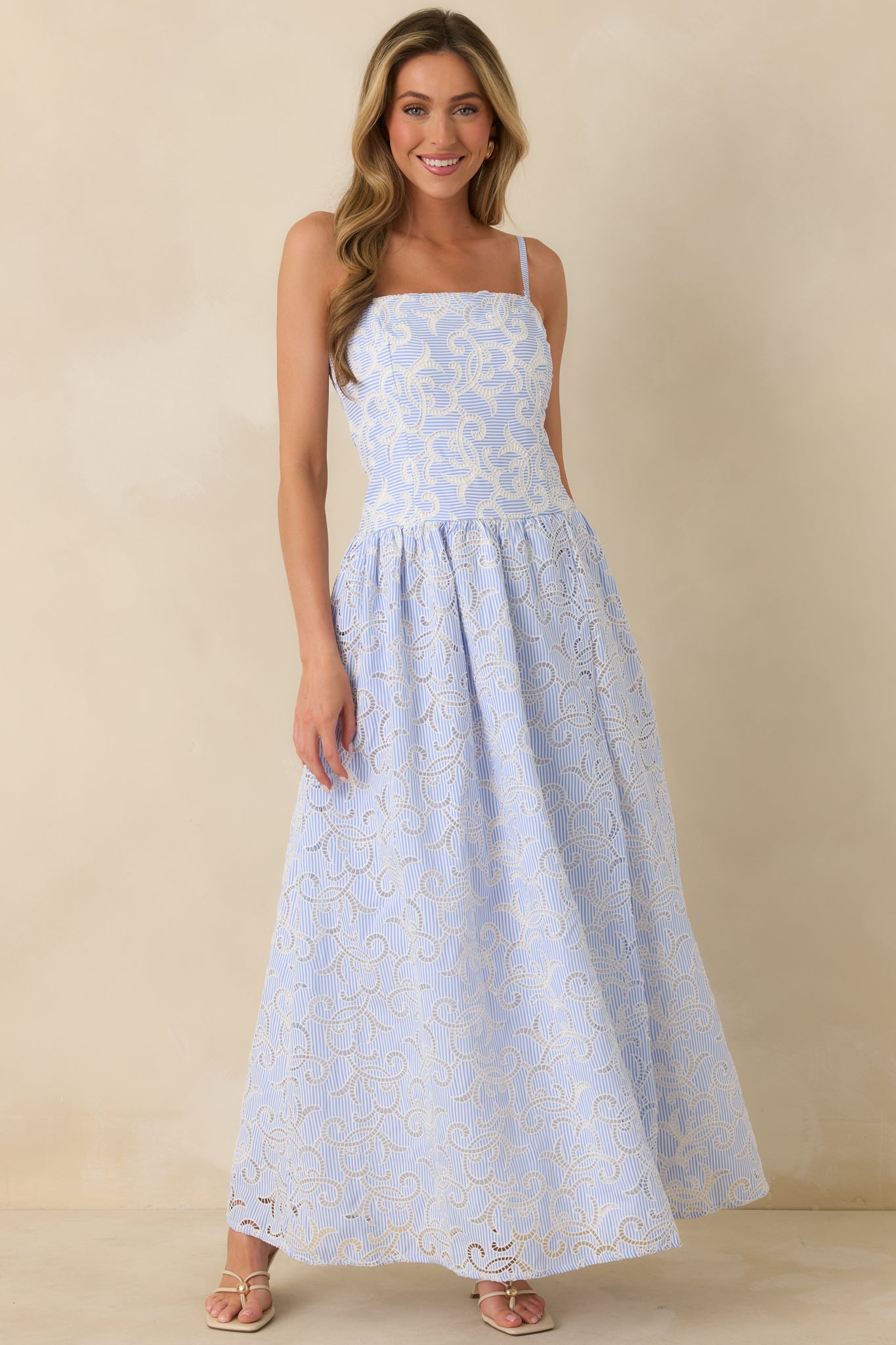 Slightly angled front view showing embroidered eyelet detailing throughout the dress and flowing hem.