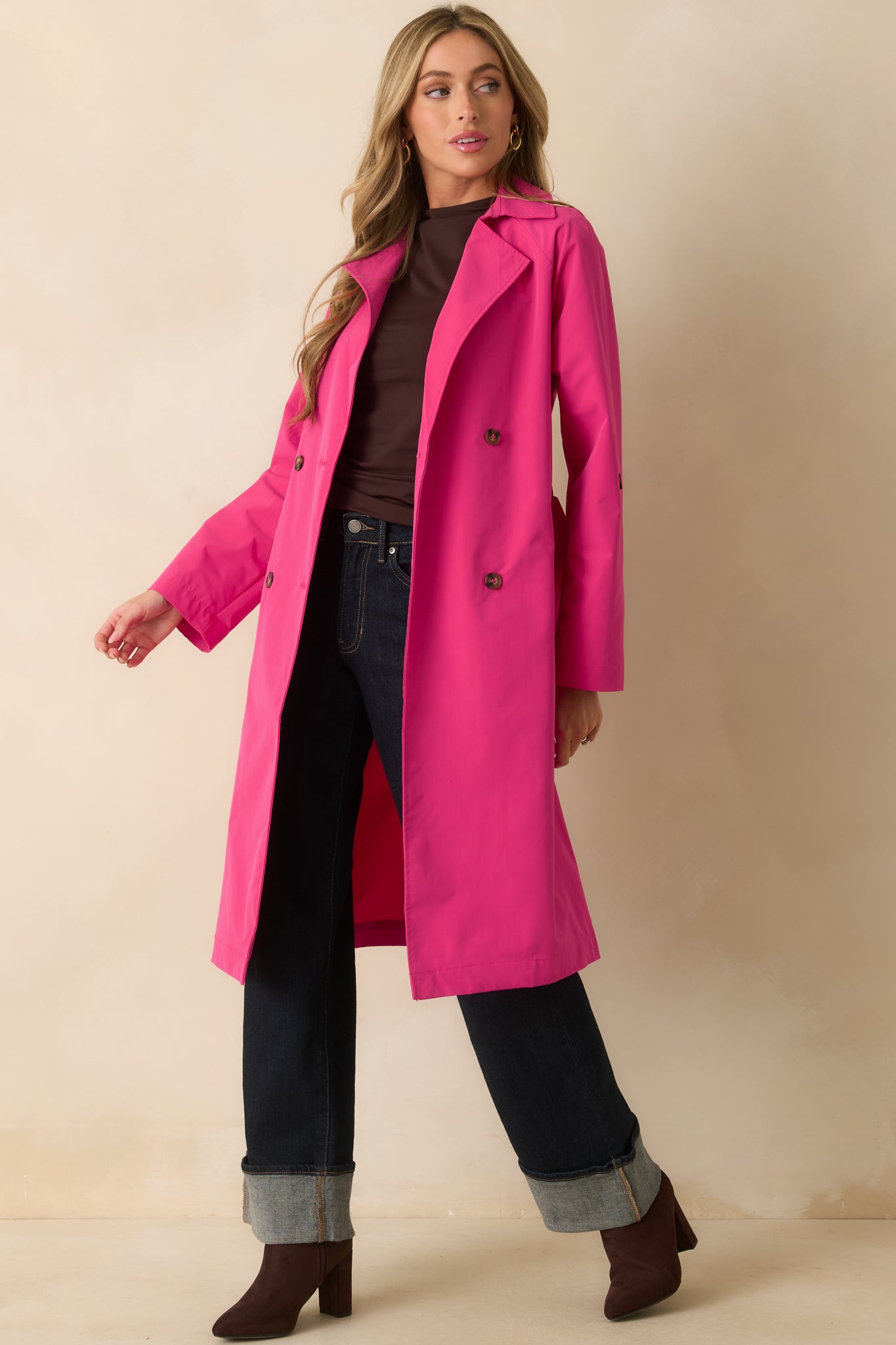Slight angled front view emphasizing the coat’s silhouette, lapel design, and long sleeves.