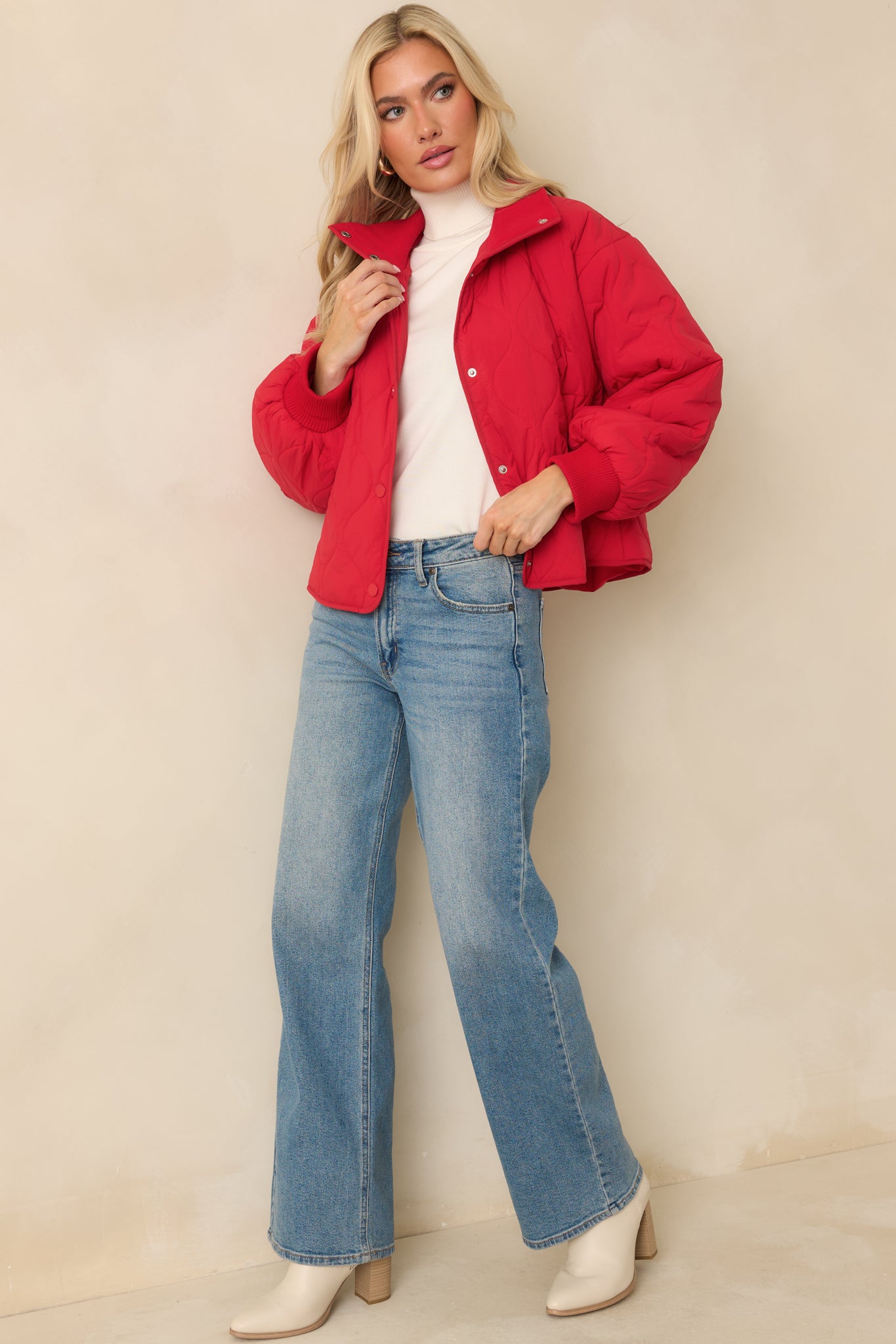 Angled full-body view emphasizing the jacket’s long sleeves and ribbed cuffs.