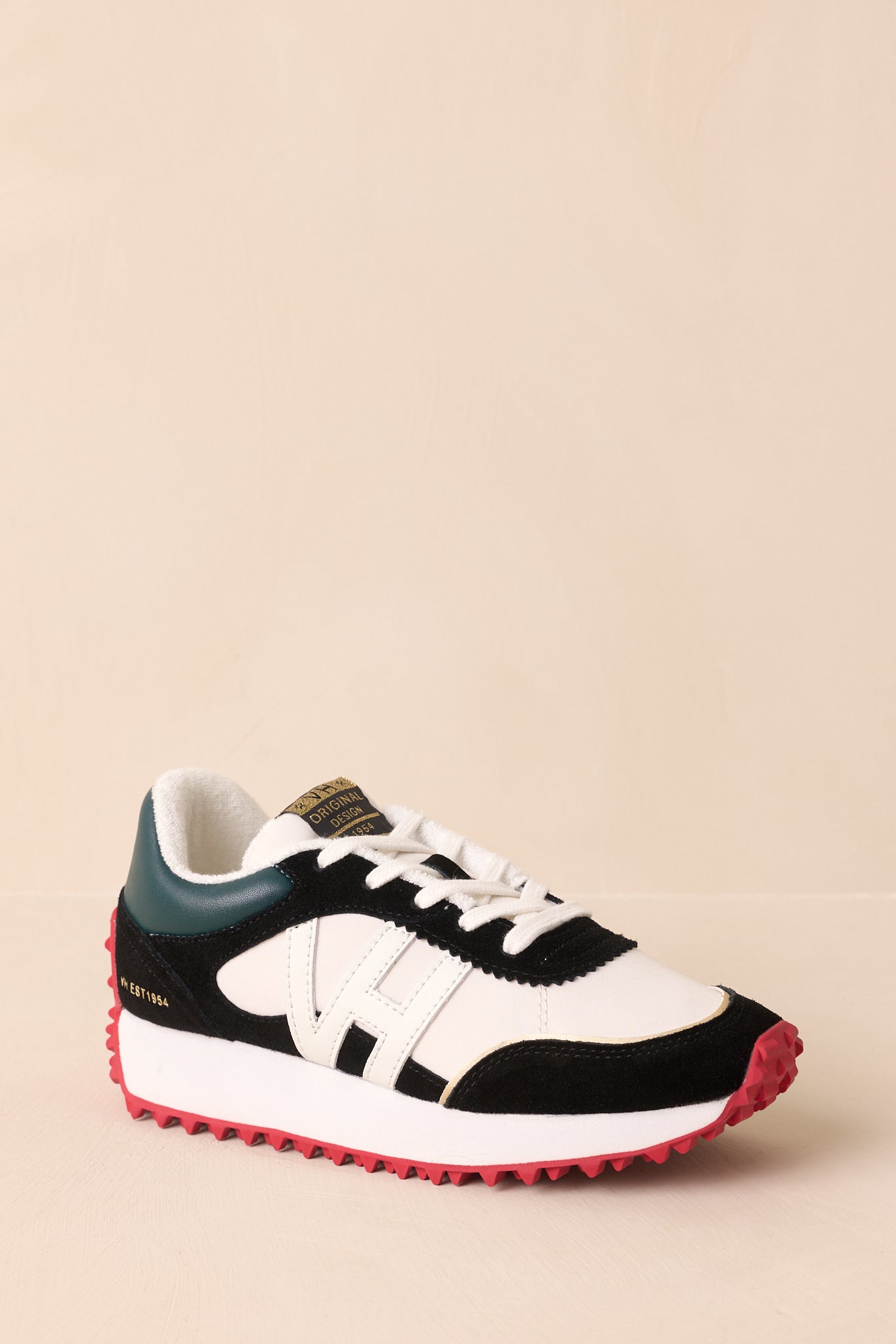 Angled view highlighting the green heel panel and contrast between textures and colors.