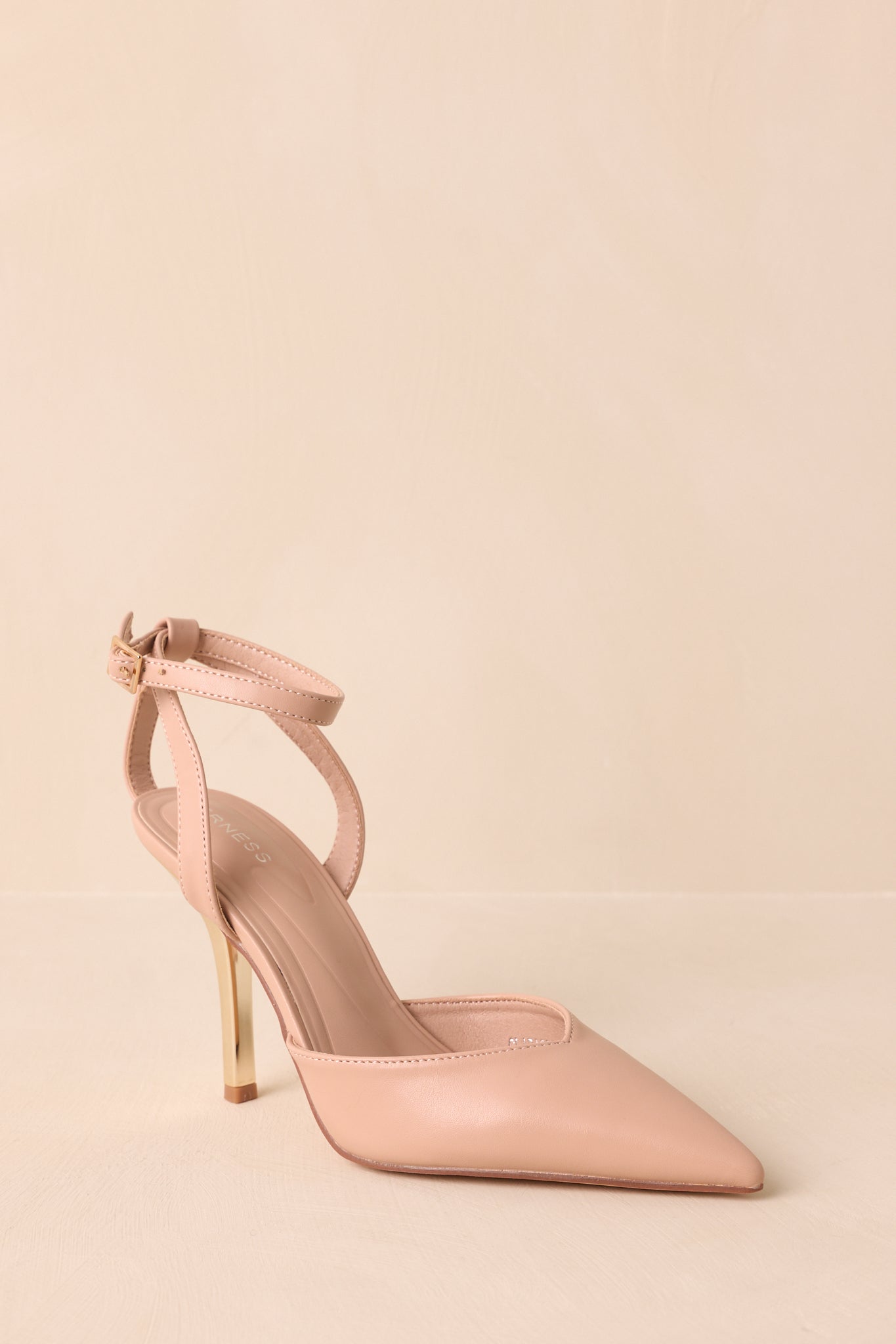 Angled perspective capturing pointed toe and slim stiletto heel together.
