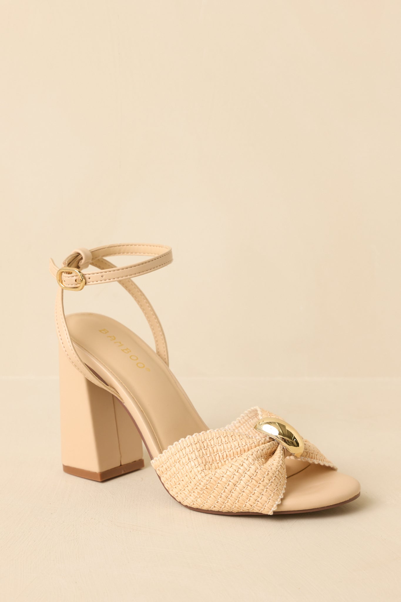 Angled view of the sandals emphasizing the woven texture and bow detail on the strap.