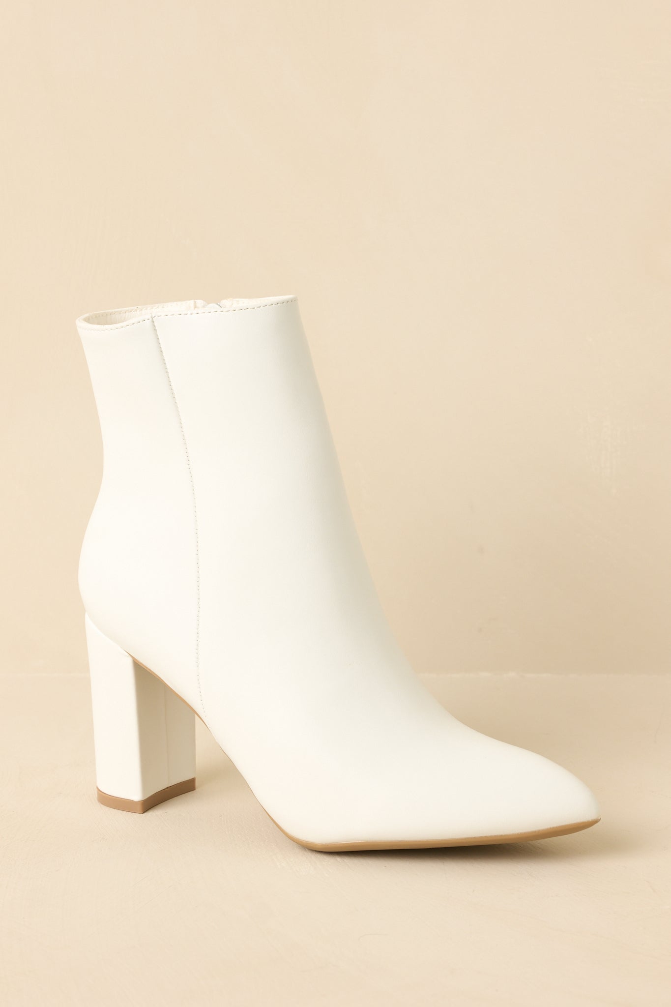 Ankle boots shown from a low angle emphasizing the block heel and structured shape.