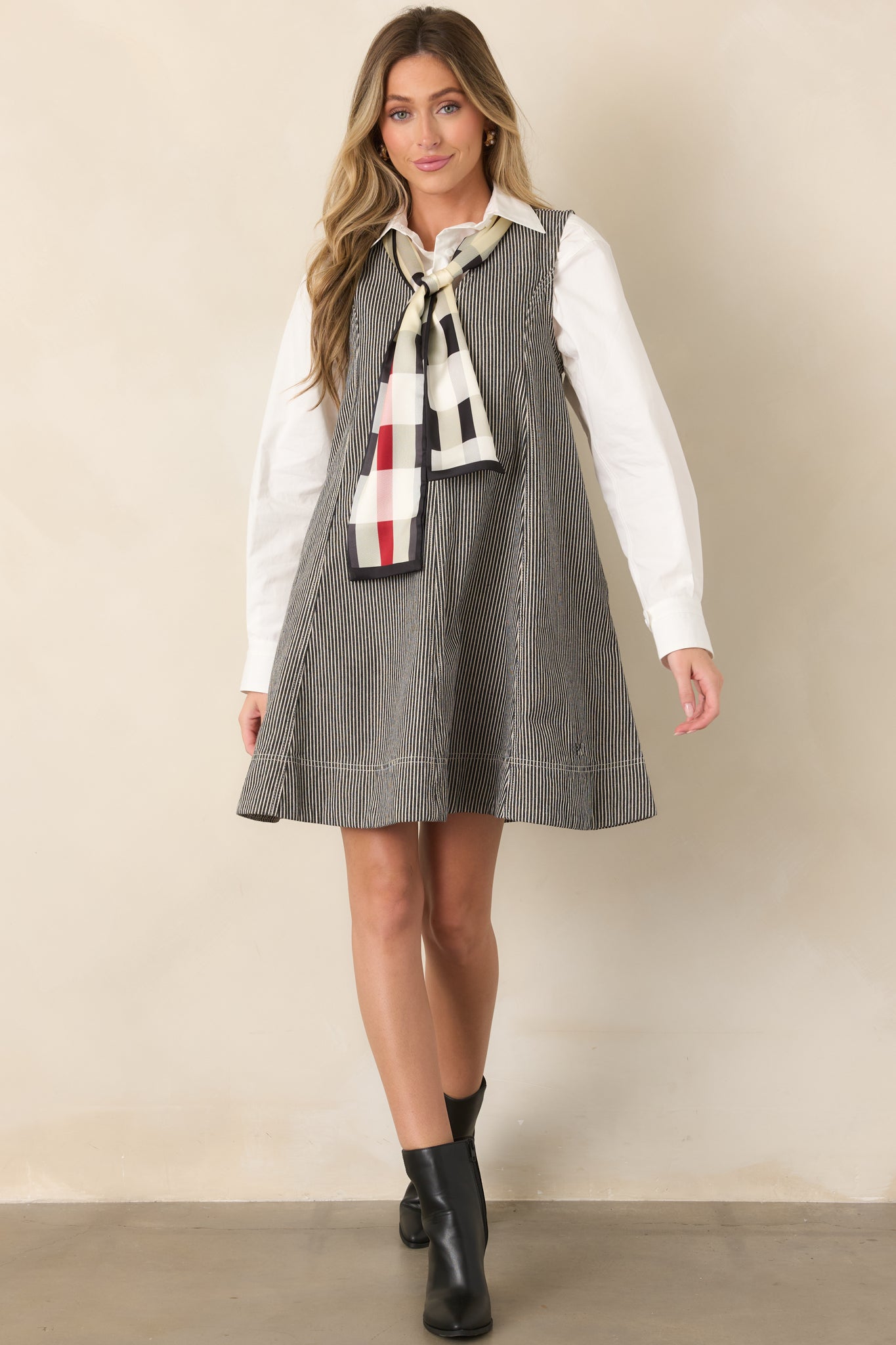 Anthracite grey mini dress with fine ivory stripes, a sleeveless cut, deep V-neckline, angled seam detailing, and flared mini hem.
