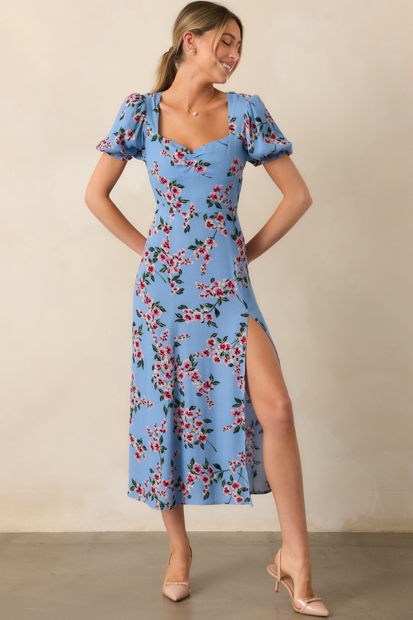 A dreamy ash blue dress designed with a sweetheart neckline, puff sleeves, and a leg slit, blending charm and comfort.