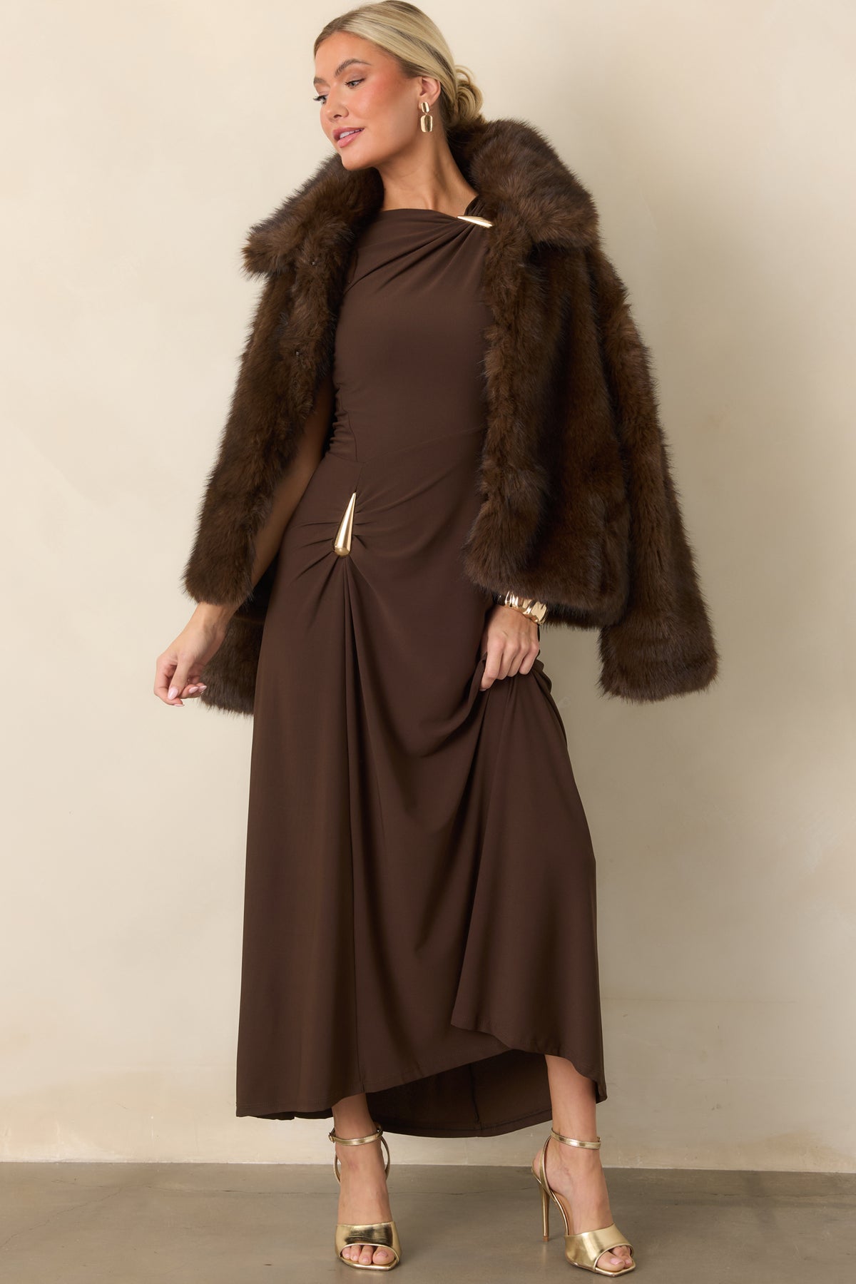 Asymmetrical dress with a gathered hip detail, sculptural teardrop accent, and flowing maxi-length skirt.
