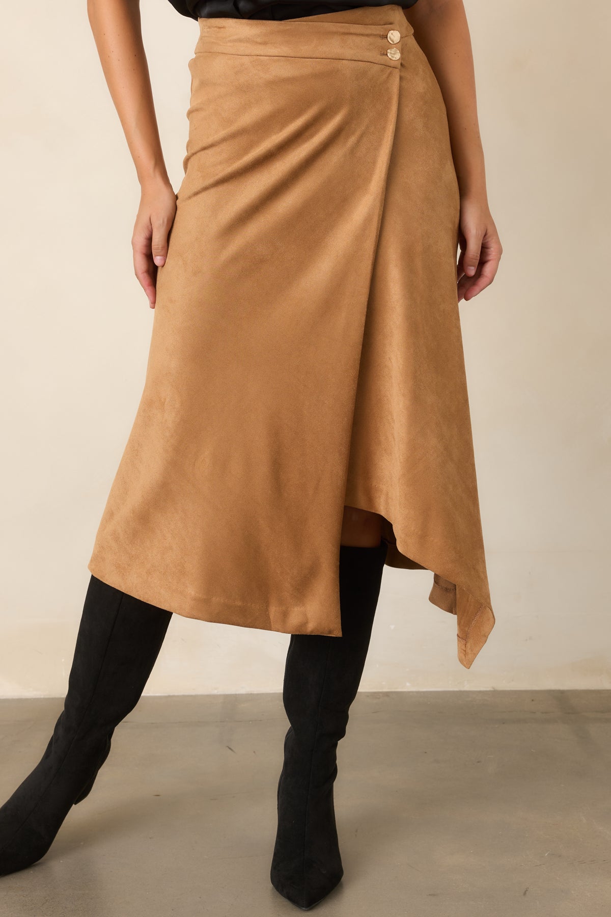 Asymmetrical wrap skirt with smooth faux suede construction and graceful draped detailing.