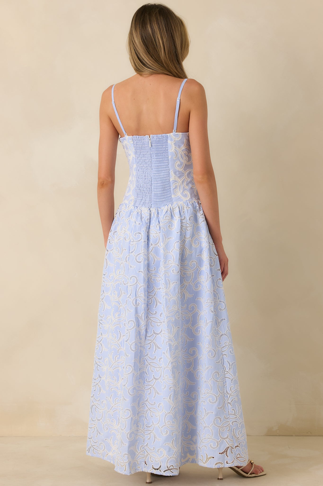 Back view highlighting the smocked back panel, hidden zipper, and optional adjustable straps.