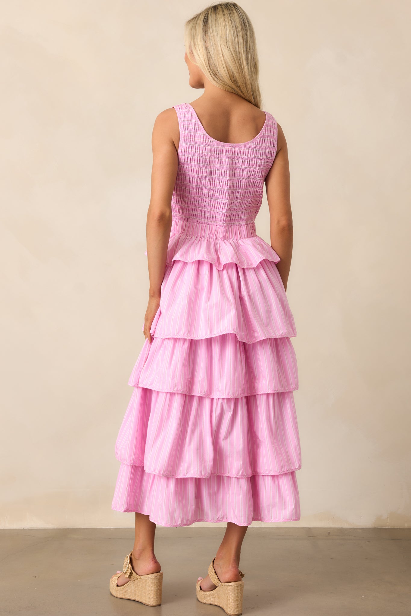  The back of the midi dress highlights the pink stripe pattern, smocked bodice, and tiered ruffle skirt, creating a seamless, stylish finish.