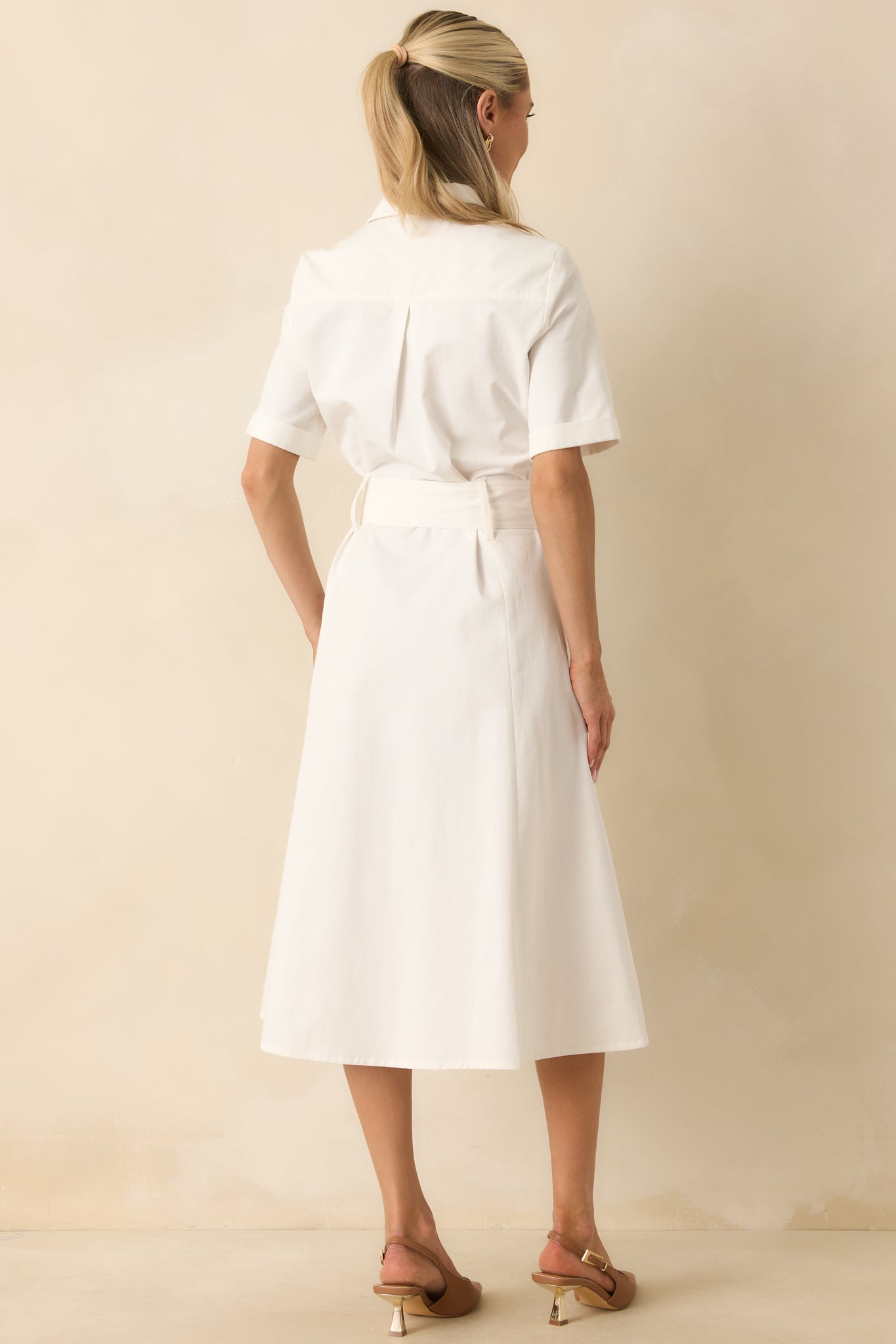 Back view of the cotton twill midi dress featuring cuffed short sleeves, a cinched waist, and a fit-and-flare silhouette.