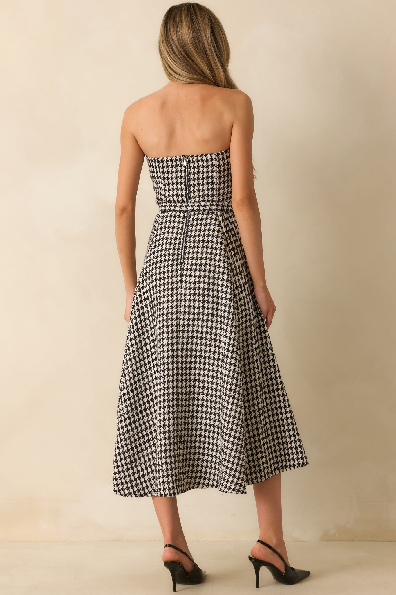Back view of the black houndstooth midi dress featuring the concealed zipper and smooth lined construction.