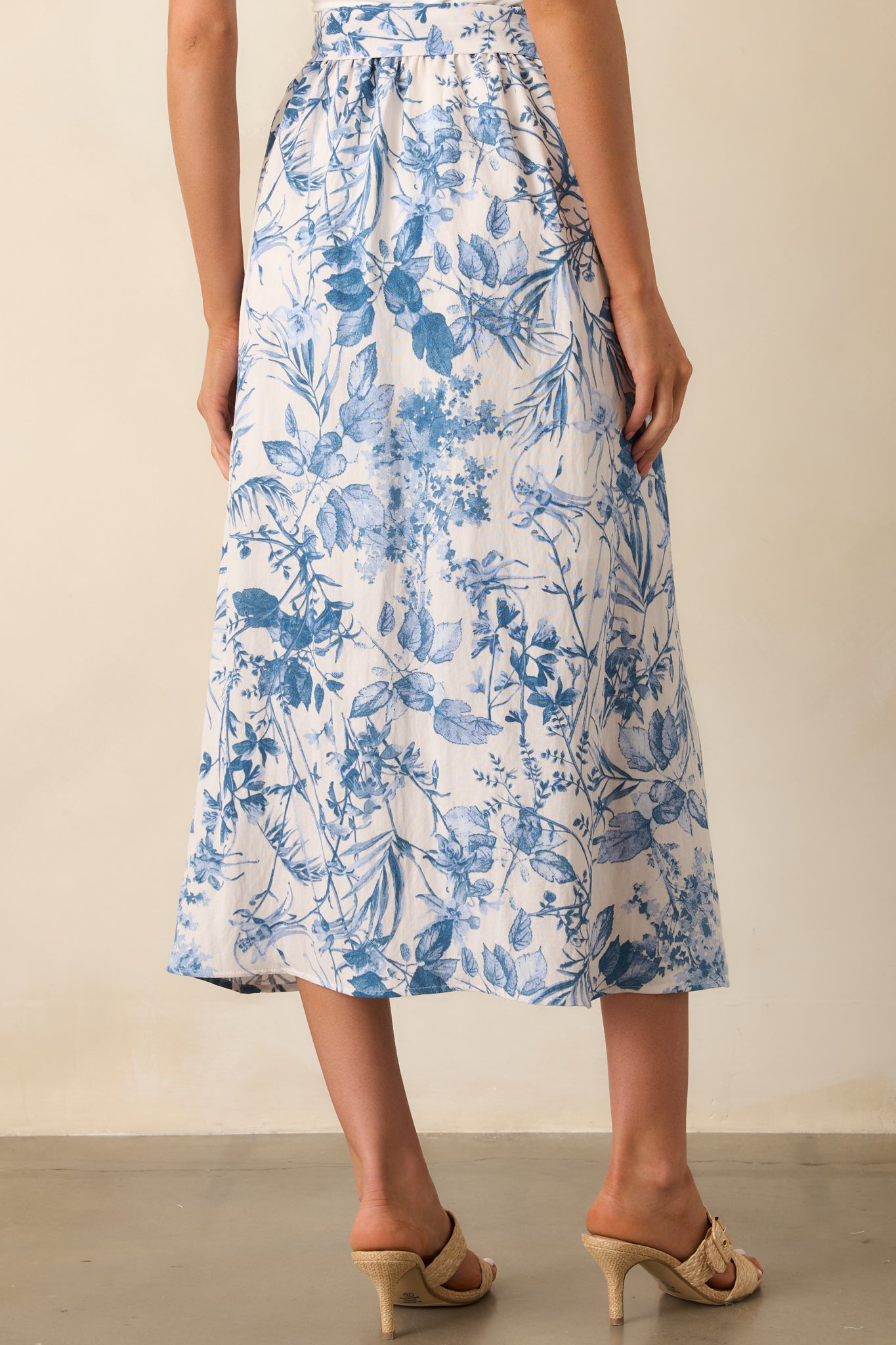 Back view of the blue floral maxi skirt showing the elastic waistband and subtle fullness of the skirt's shape.