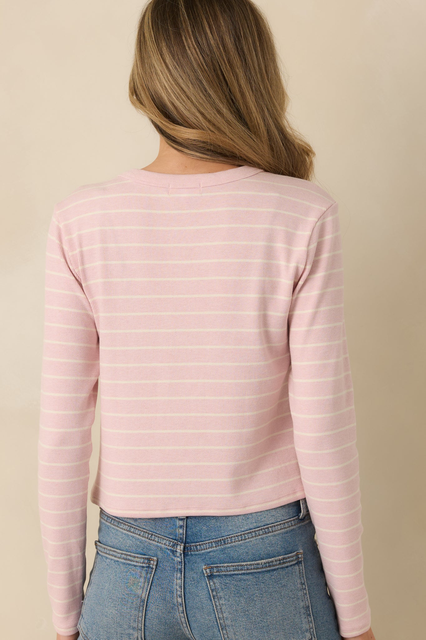 Back view of the blush pink cropped top showing the fitted silhouette and clean back neckline.