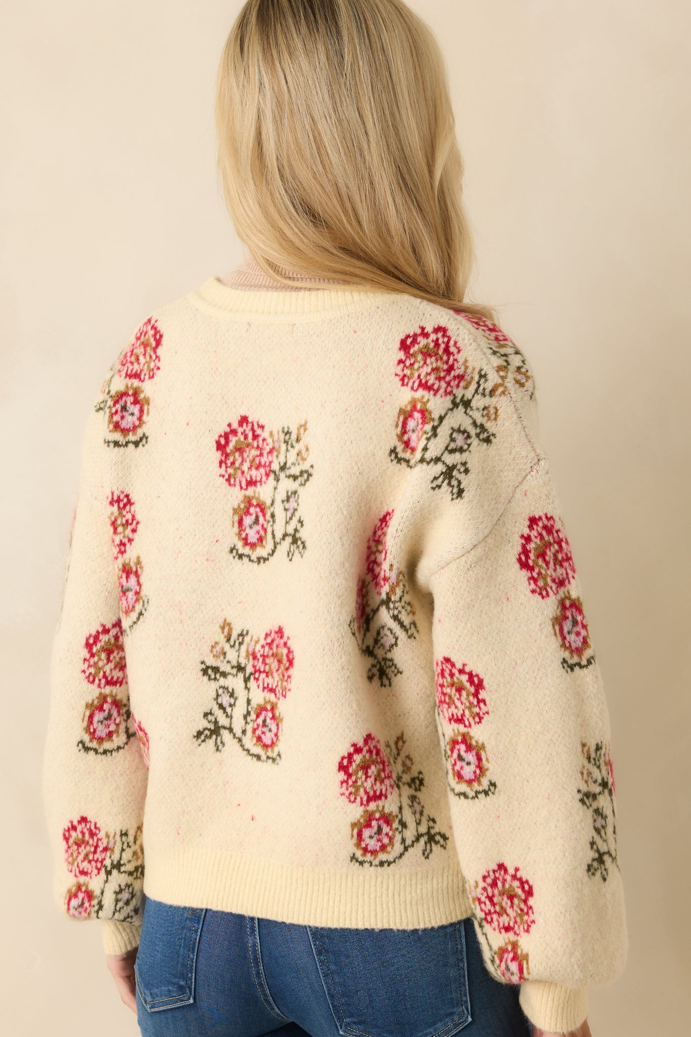 Back view of the cardigan showing its relaxed drape and smooth, uninterrupted ivory knit.