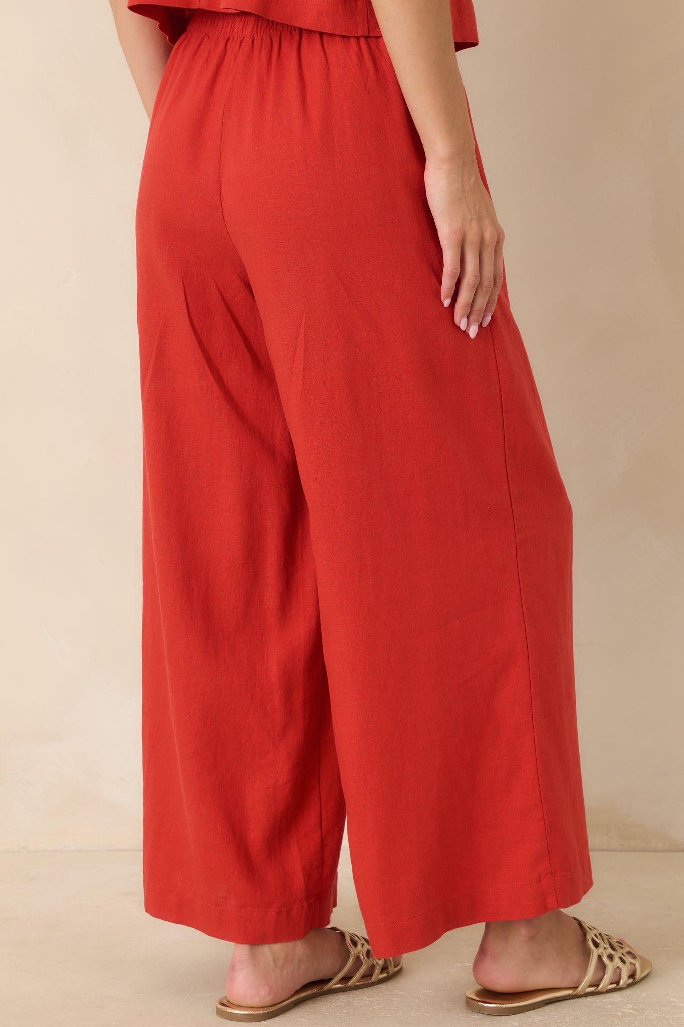 Back view of chili pepper red pants featuring a relaxed fit and clean silhouette.