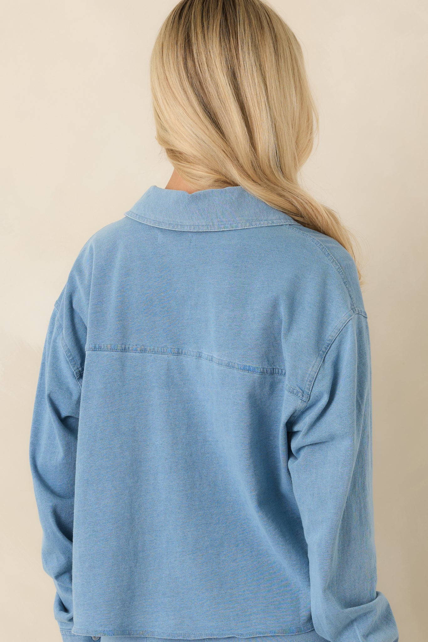 Back view of the cropped collared top highlighting the relaxed fit and clean silhouette.
