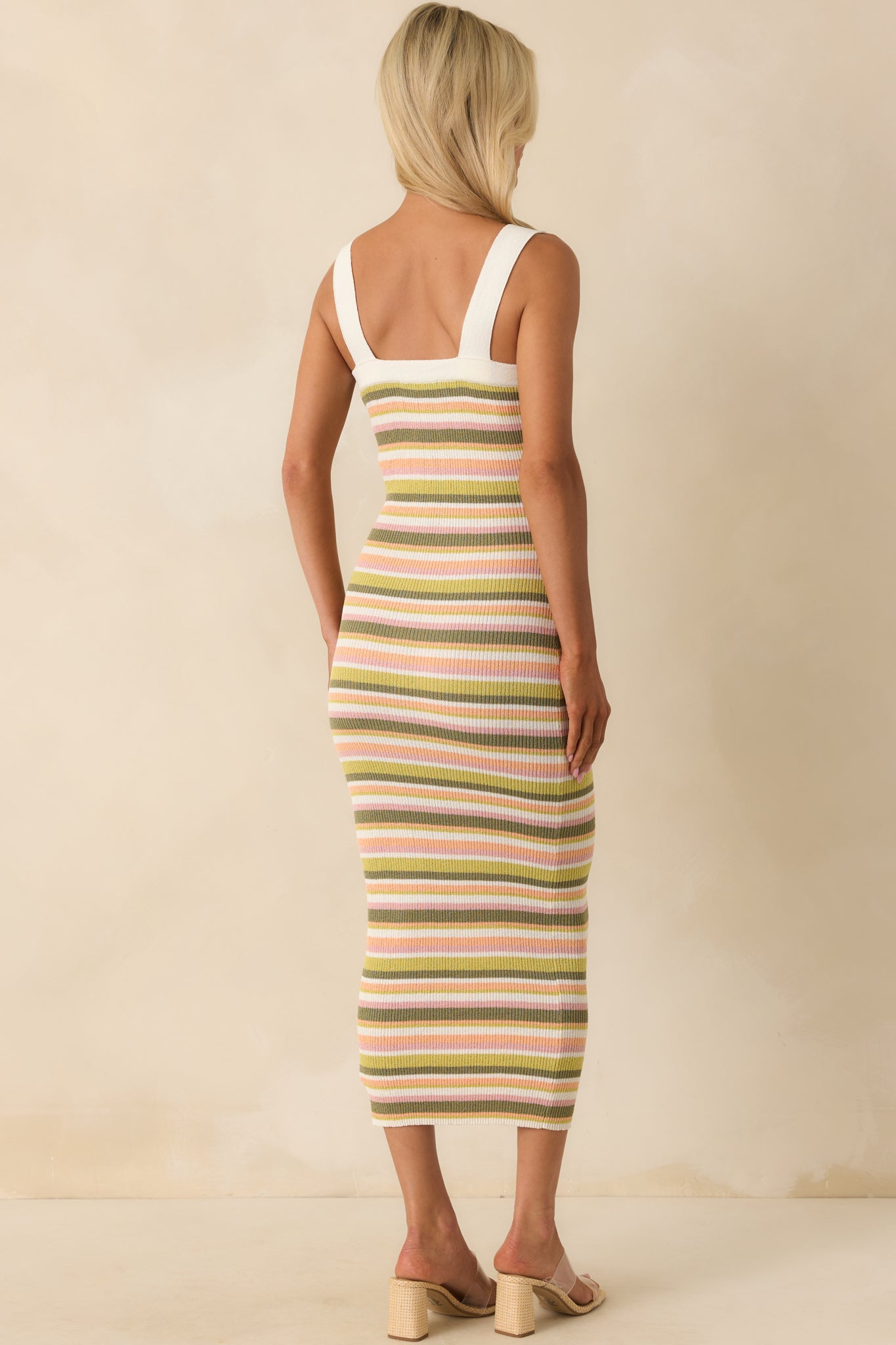 A back view displaying the continuation of the multicolor stripe pattern and the bodycon fit in the stretchy knit fabric.