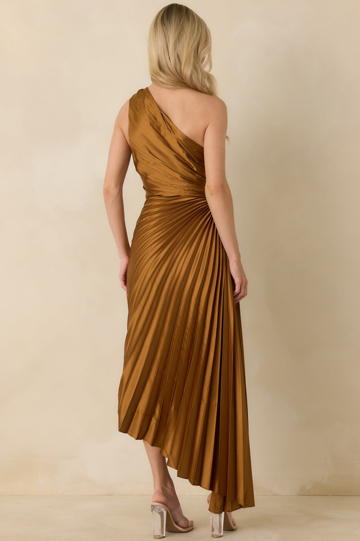 Back view of bronze maxi dress displaying concealed zipper closure, pleated skirt, and smooth lining.