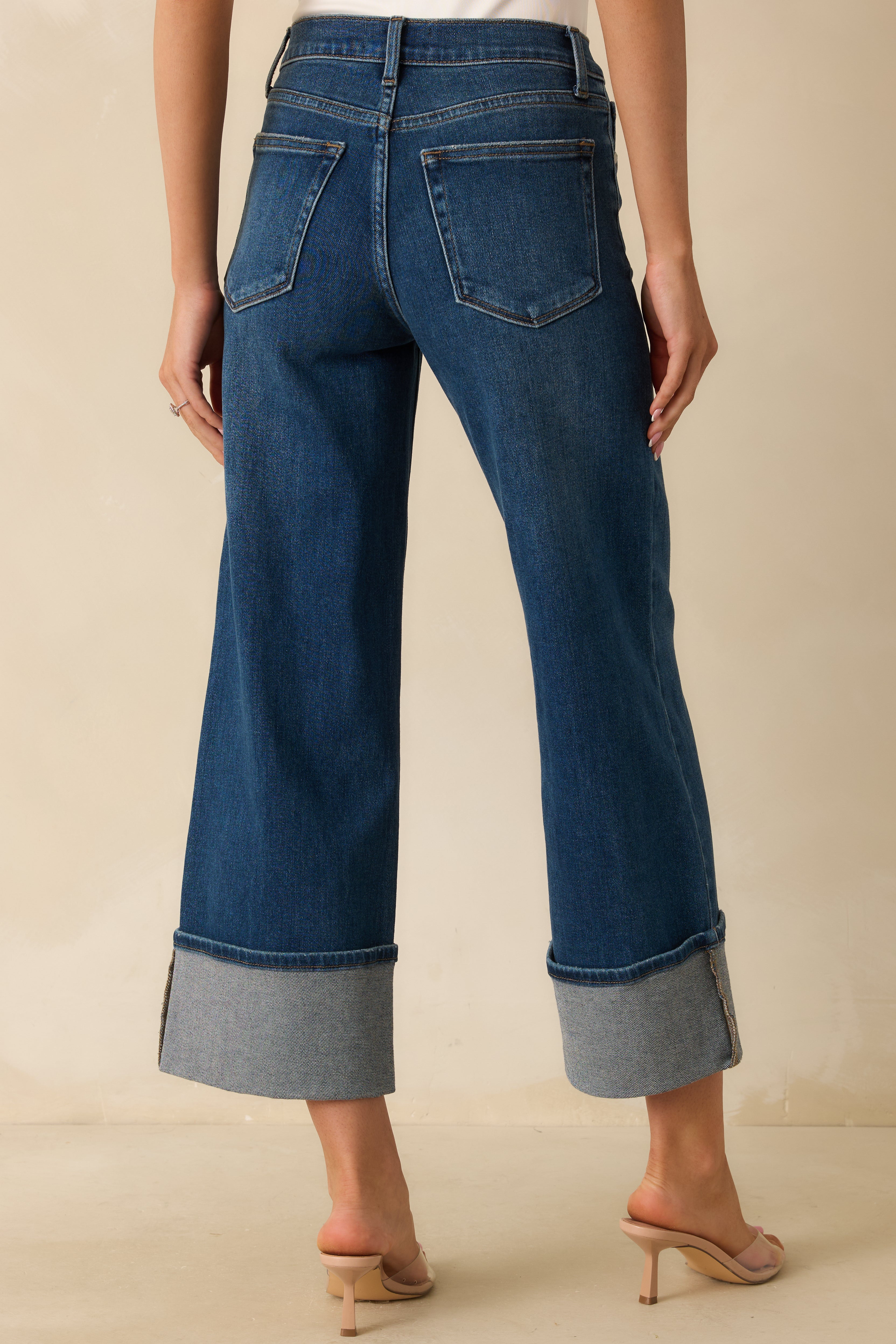 Back view of the jeans displaying the back pockets, wide-leg silhouette, and cuffed hems.