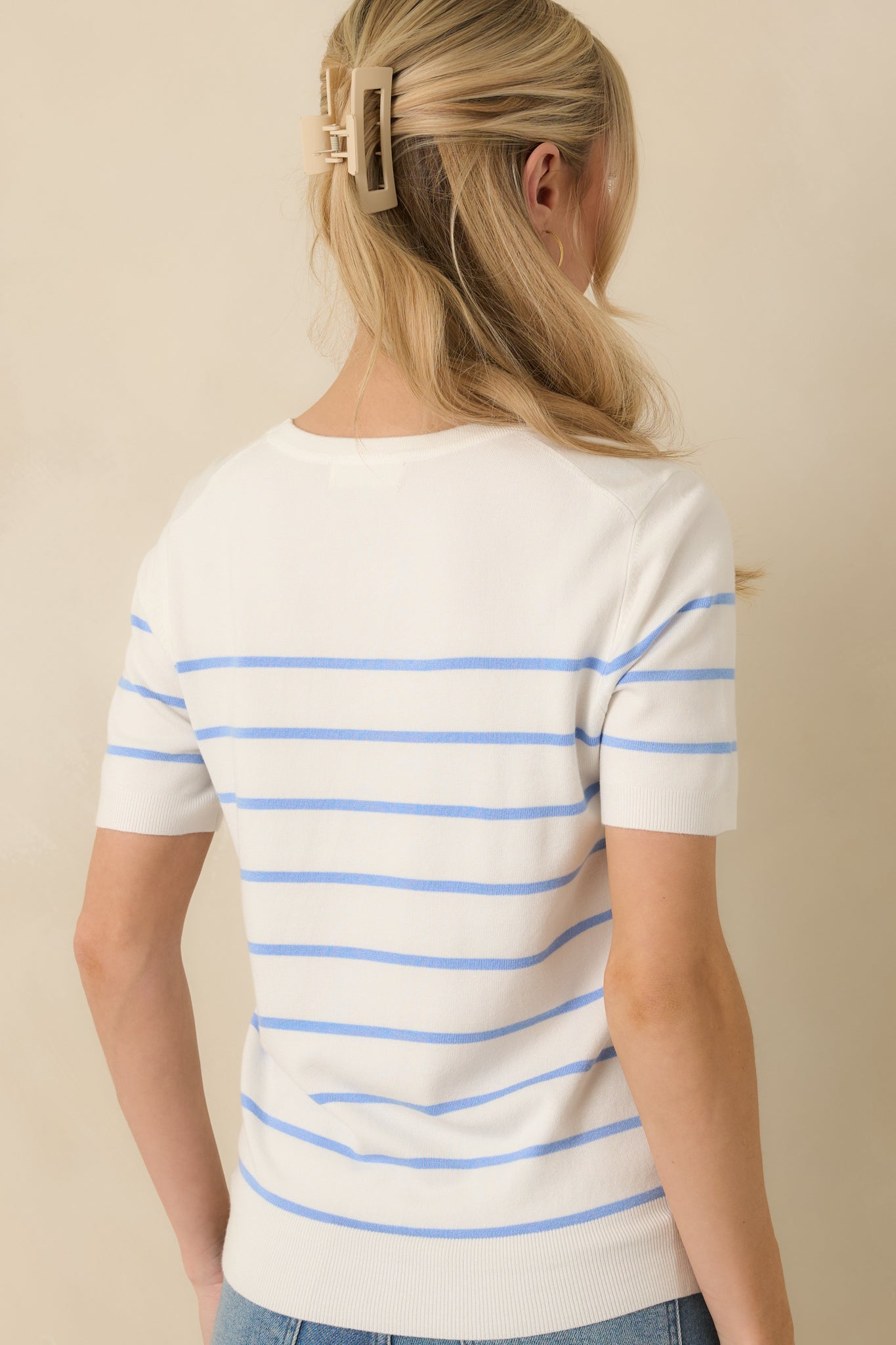 Back view of the blue striped knit sweater displaying the clean, structured fit and lightweight fabric drape.
