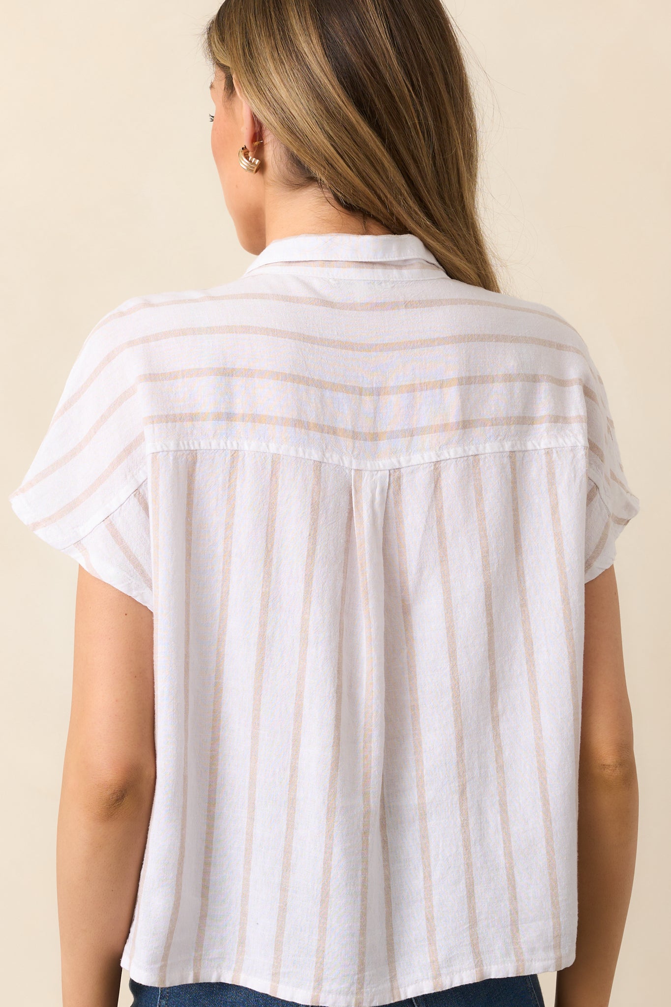 Back view of the striped top, displaying the cement beige and white stripes continuing across the back and the relaxed, straight fit.