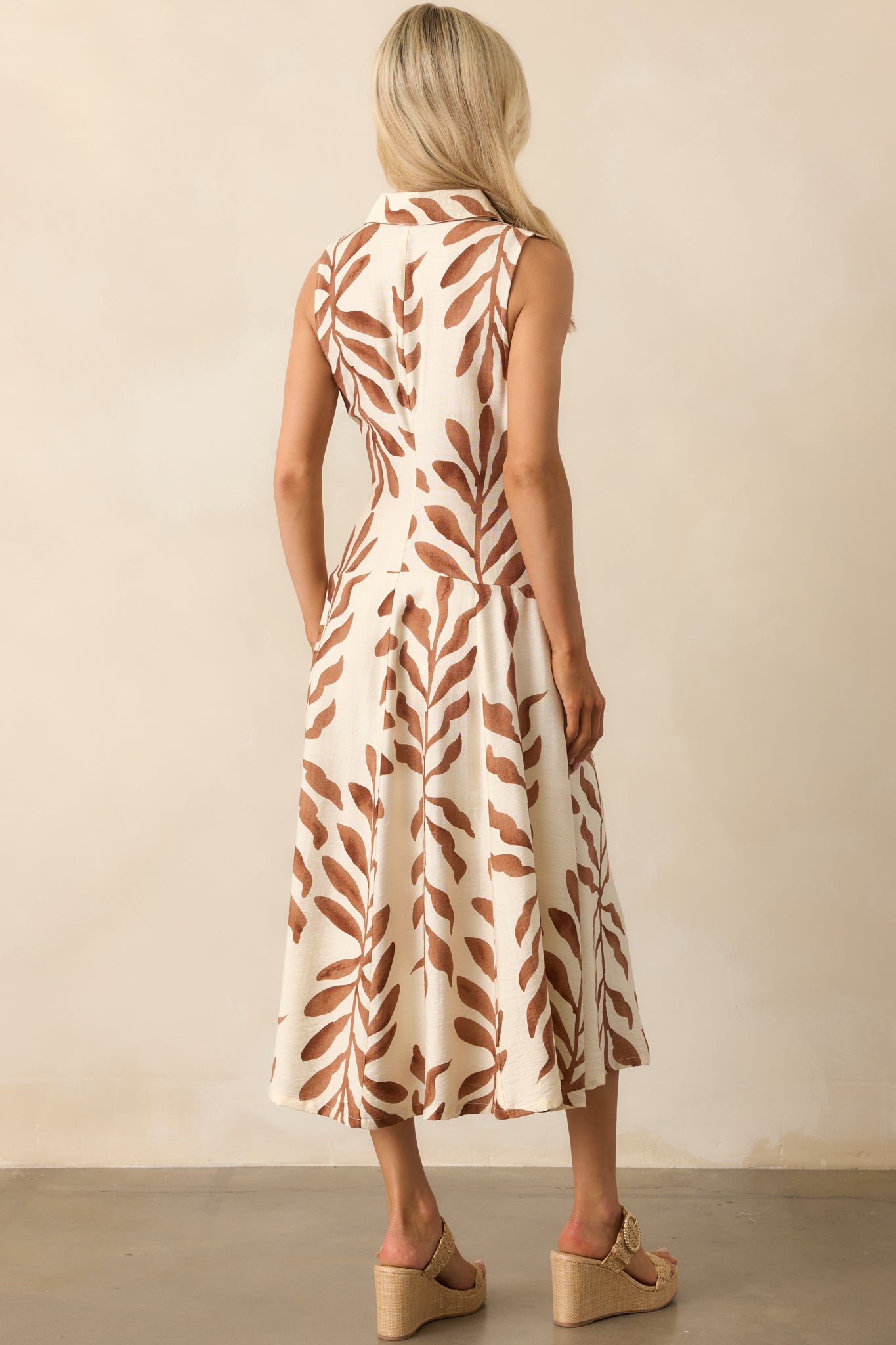 Back view of the dress displaying the continuation of the botanical print and the clean lines of the drop waist silhouette.